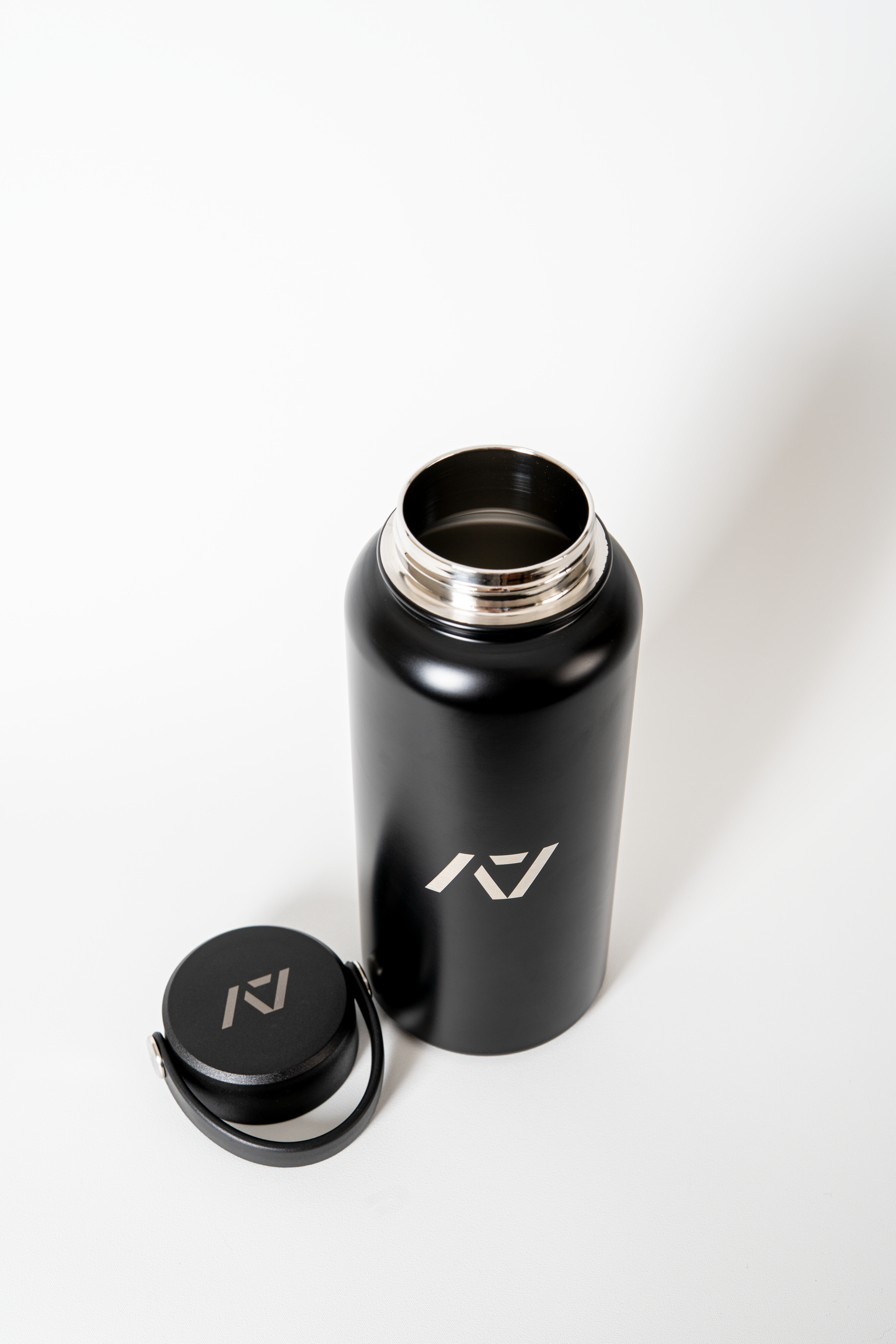 Black water bottle with lid on a white background