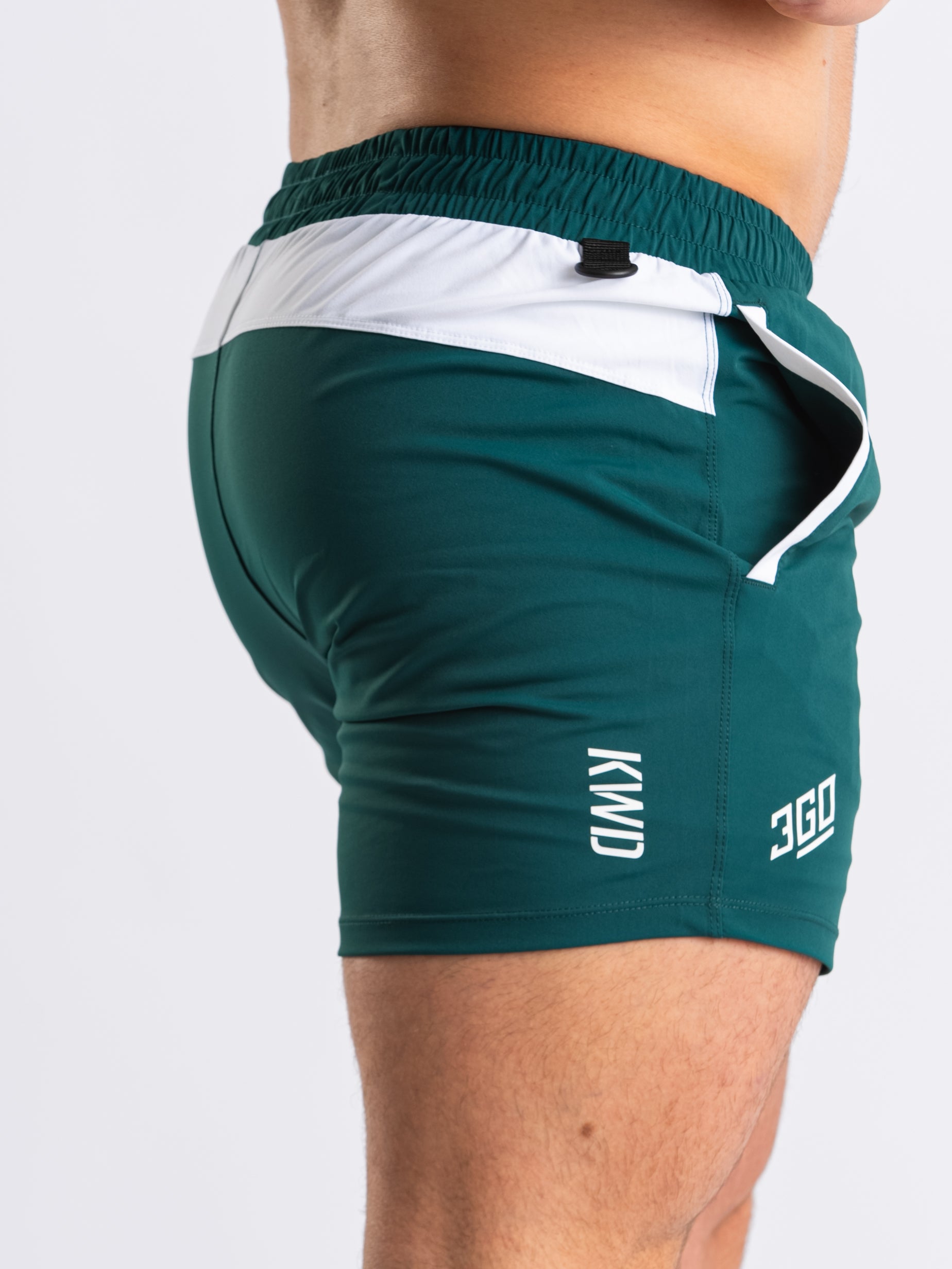 Close-up of matte silicone A7 logos on the Emerald Forás 360Go 1Z KWD Shorts, providing a sleek and durable finish.