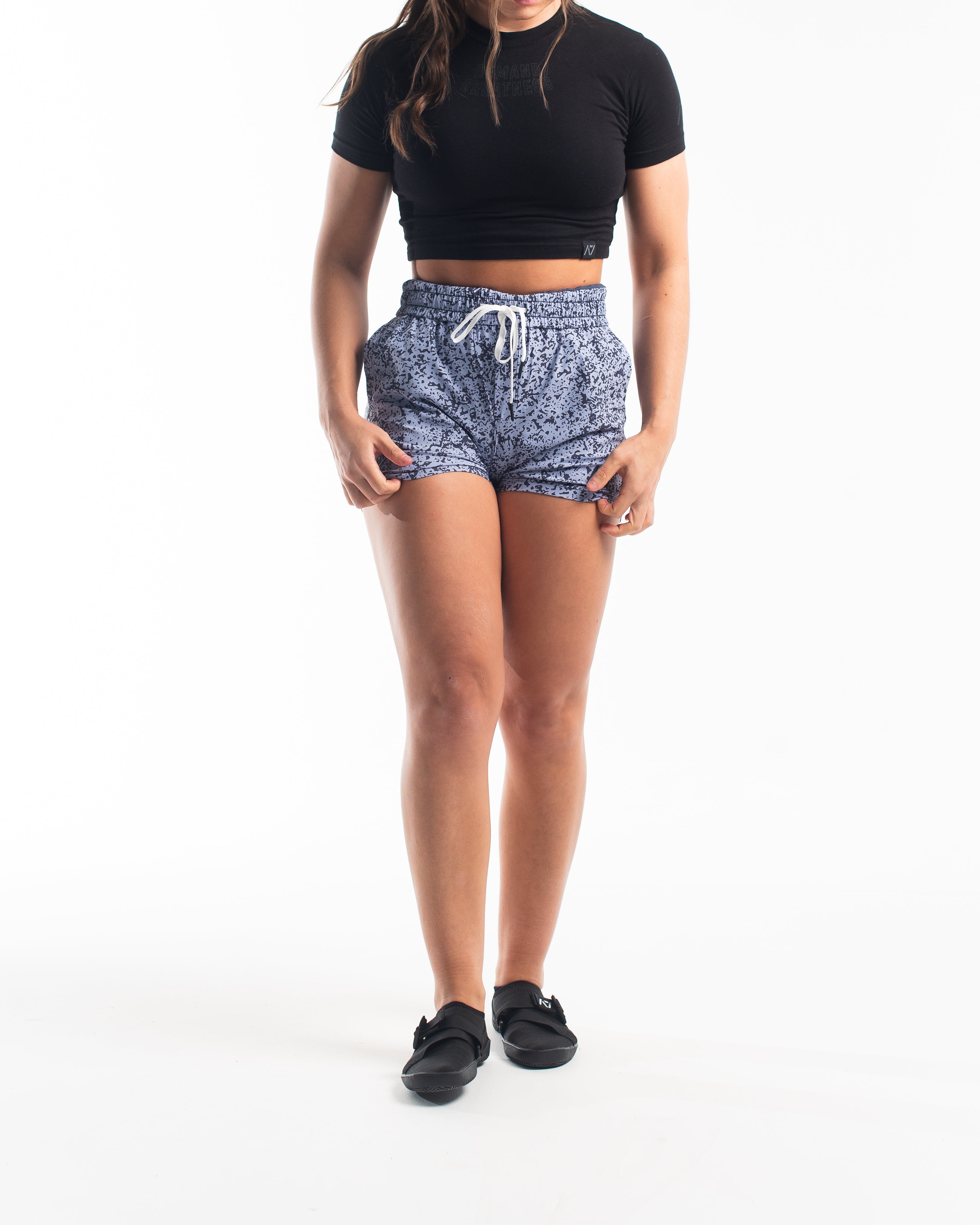 Front view of A7 360Go 1Z KWD Shorts in Foggy Navy featuring built-in liner and matte silicone logos on women.
