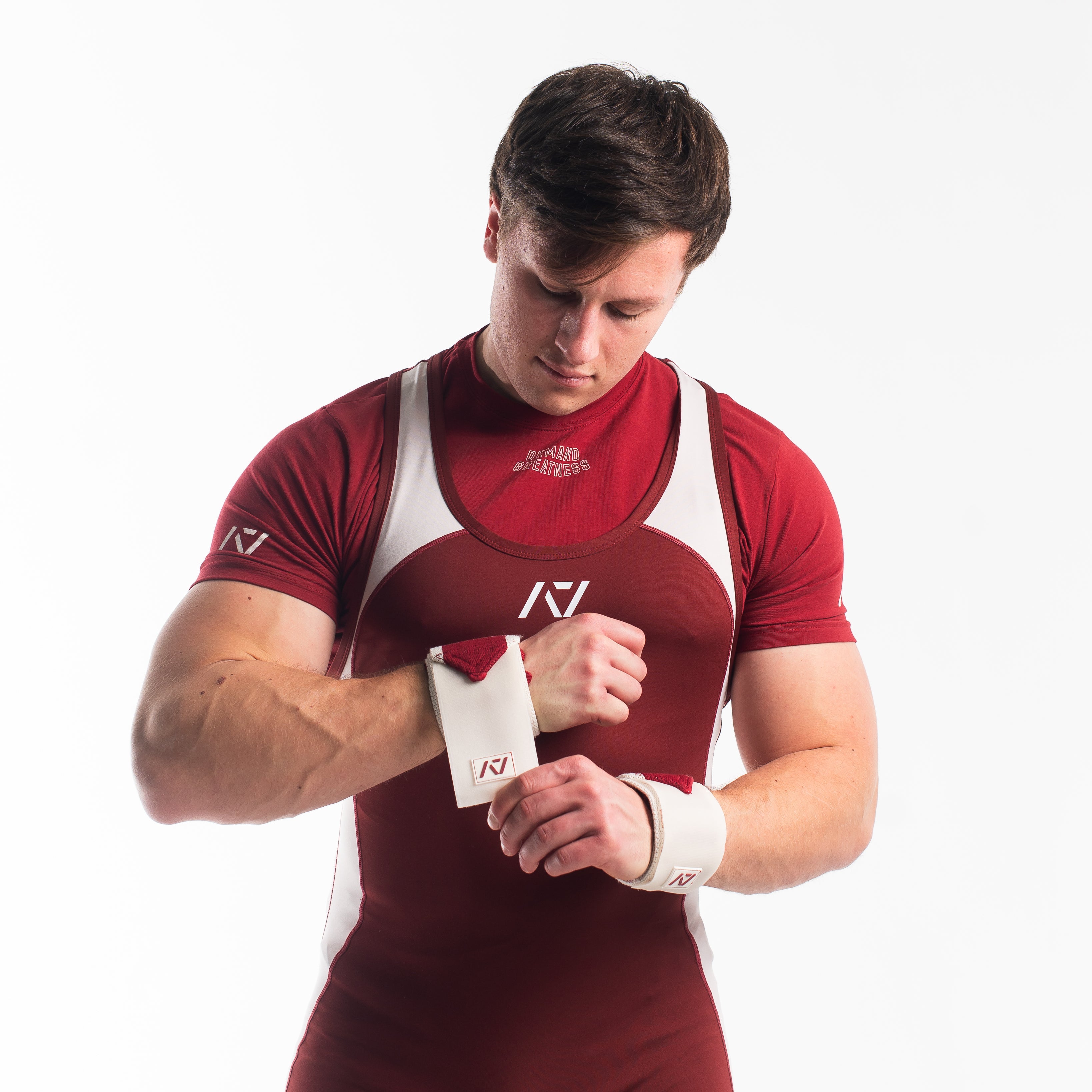 Male model in Ivory Rose Meet Kit putting on the Ivory Rose wrist wraps