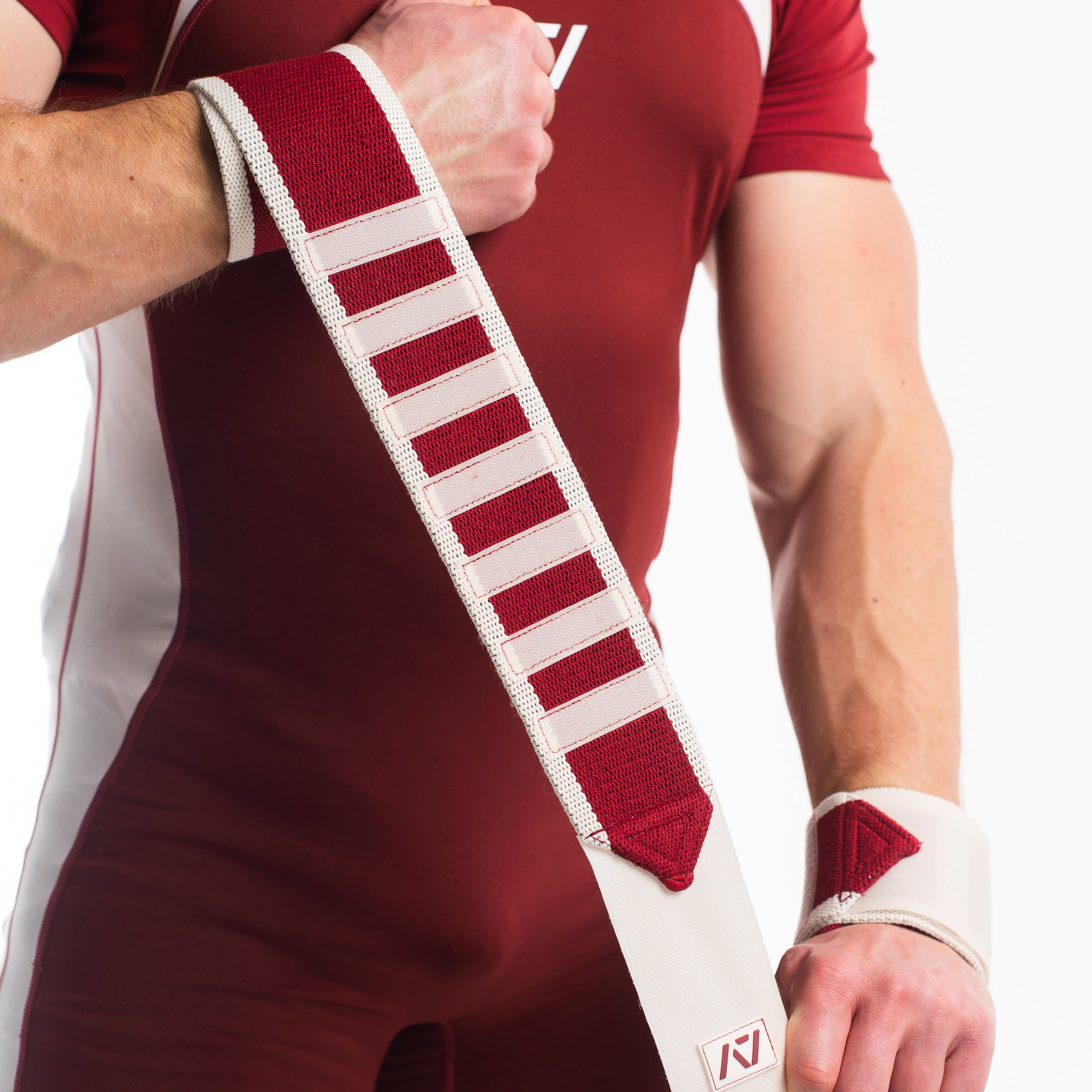 Showcasing the material stretch of the ivory rose wrist wraps