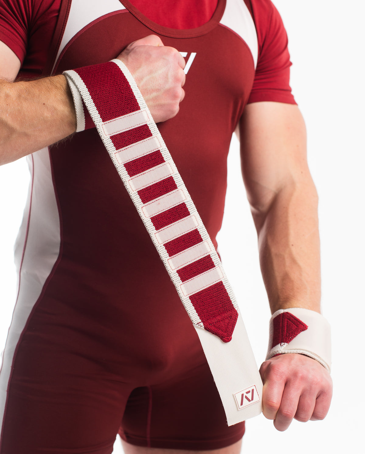 Showcasing the material stretch of the ivory rose wrist wraps