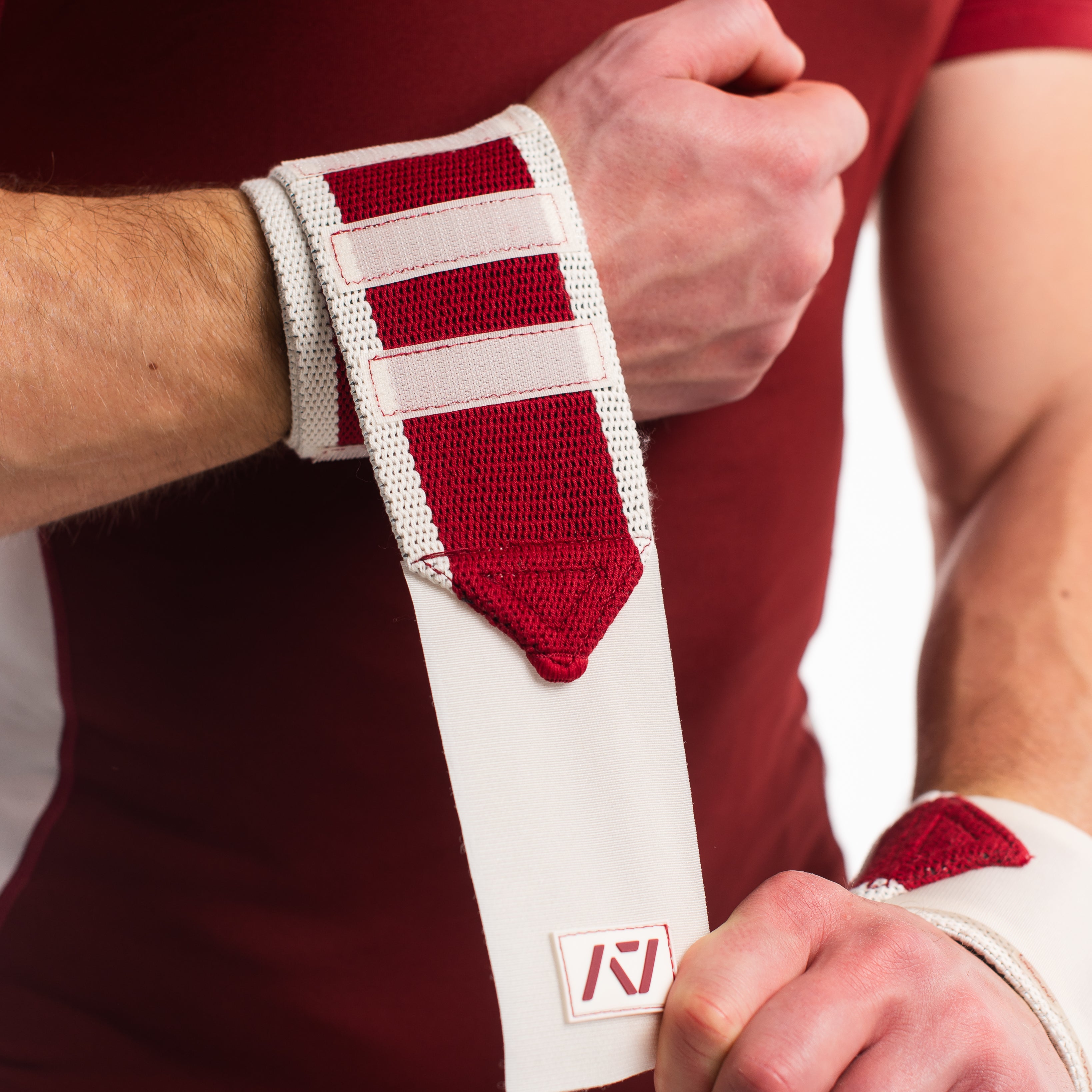 Close up of male model putting on ivory rose wrist wraps