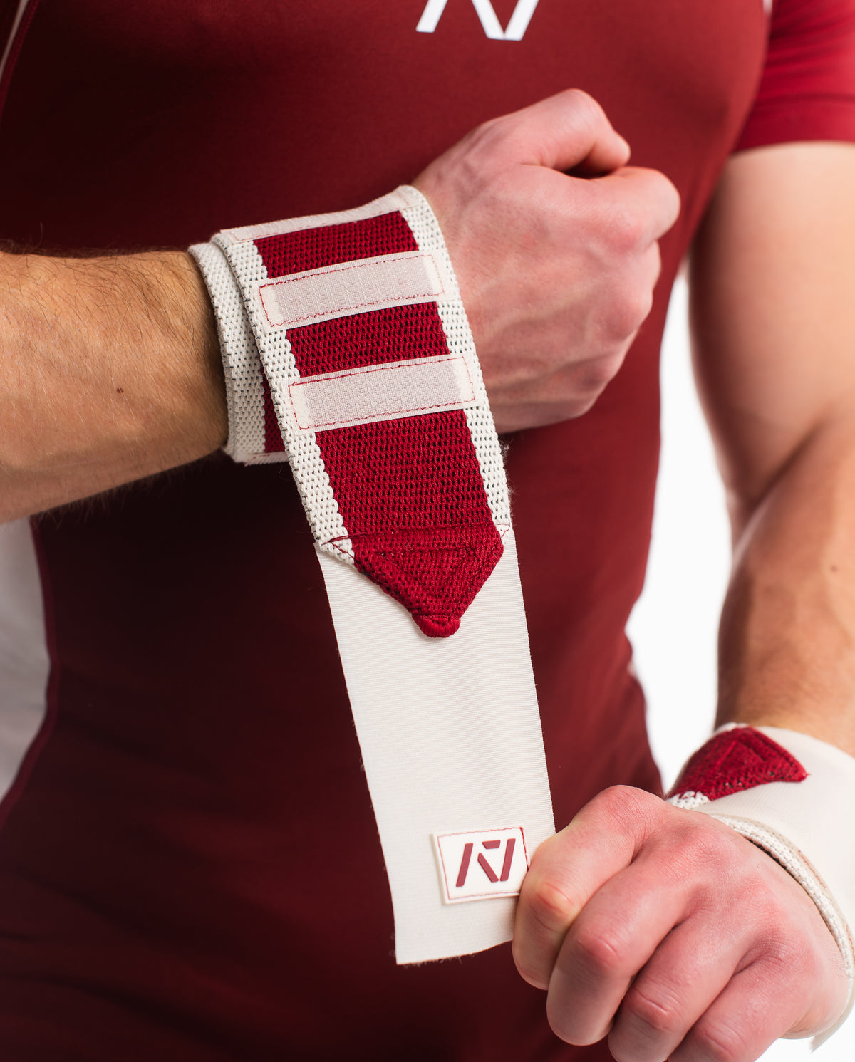 Close up of male model putting on ivory rose wrist wraps