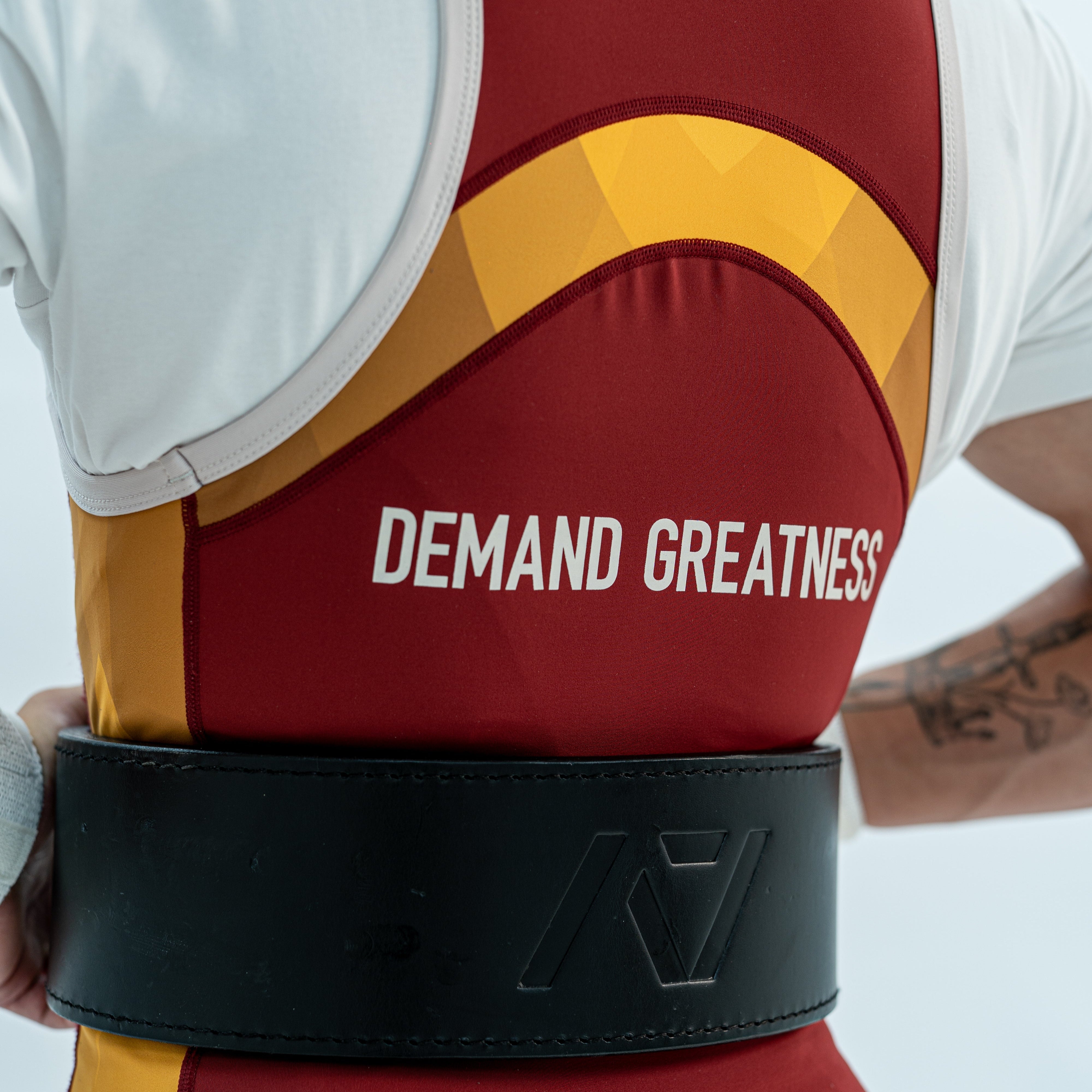 Close up of the back DEMAND GREATNESS lettering and cut of the rausch singlet