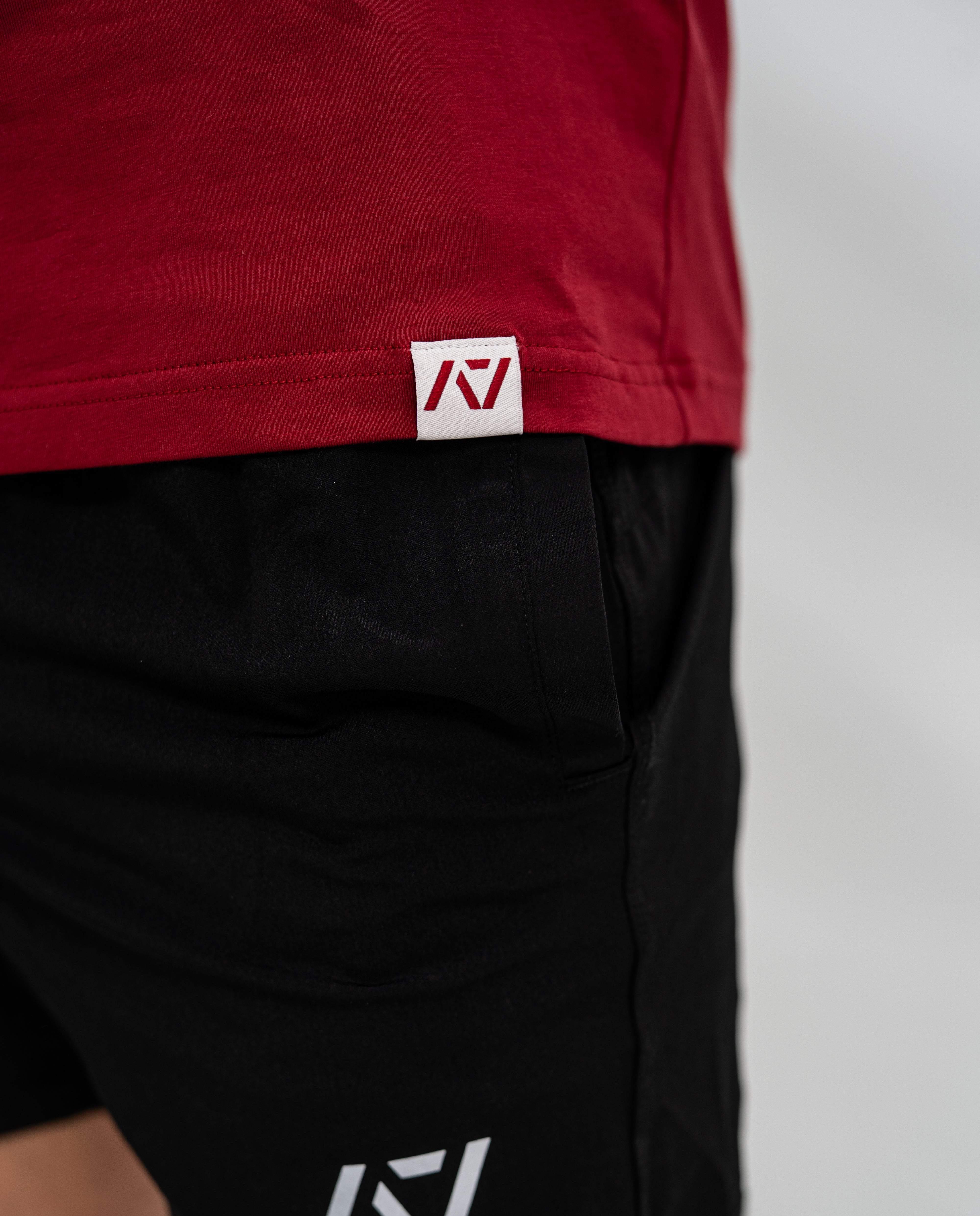 Red Bar Grip Shirt with a logo on a plain background