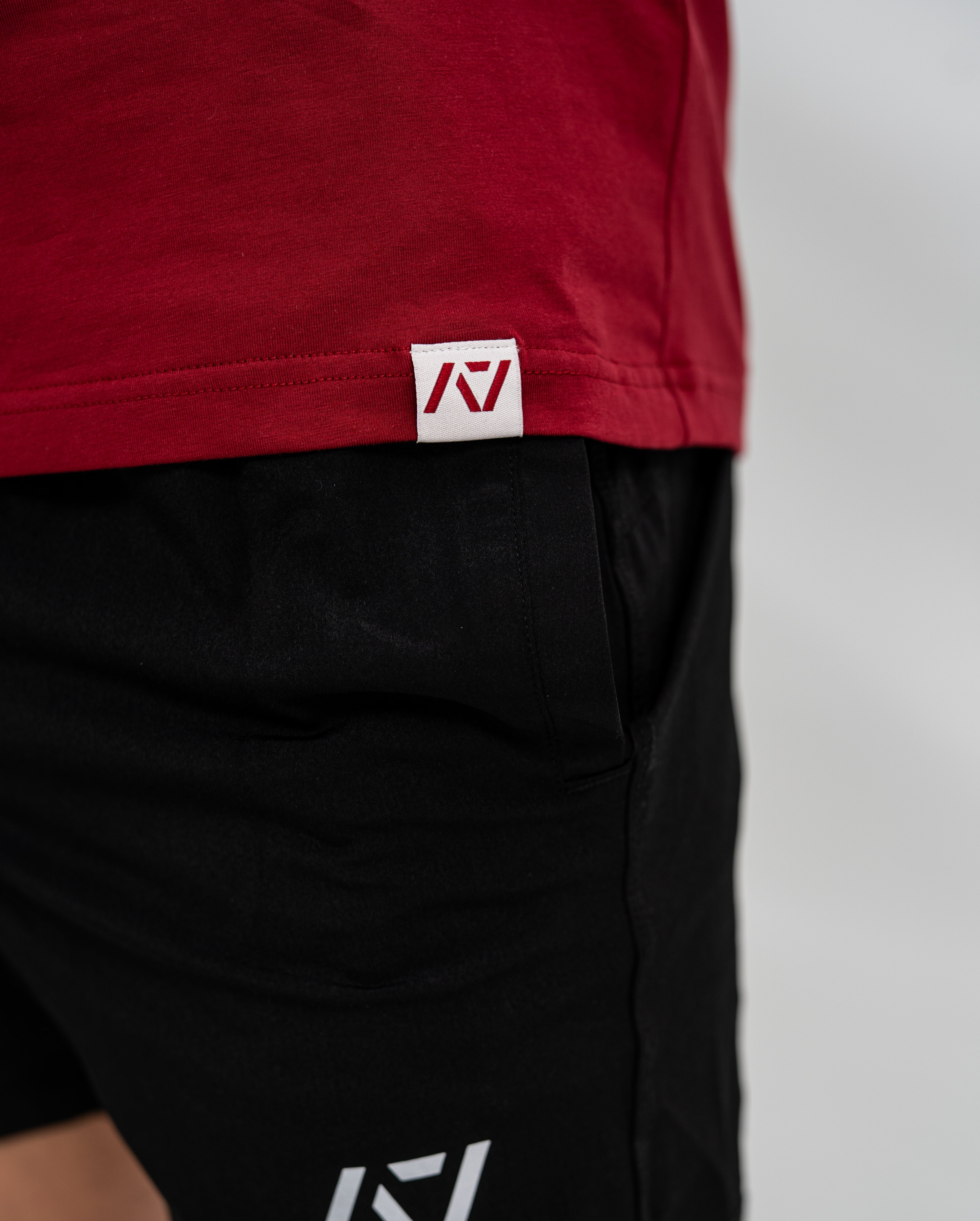Red Bar Grip Shirt with a logo on a plain background