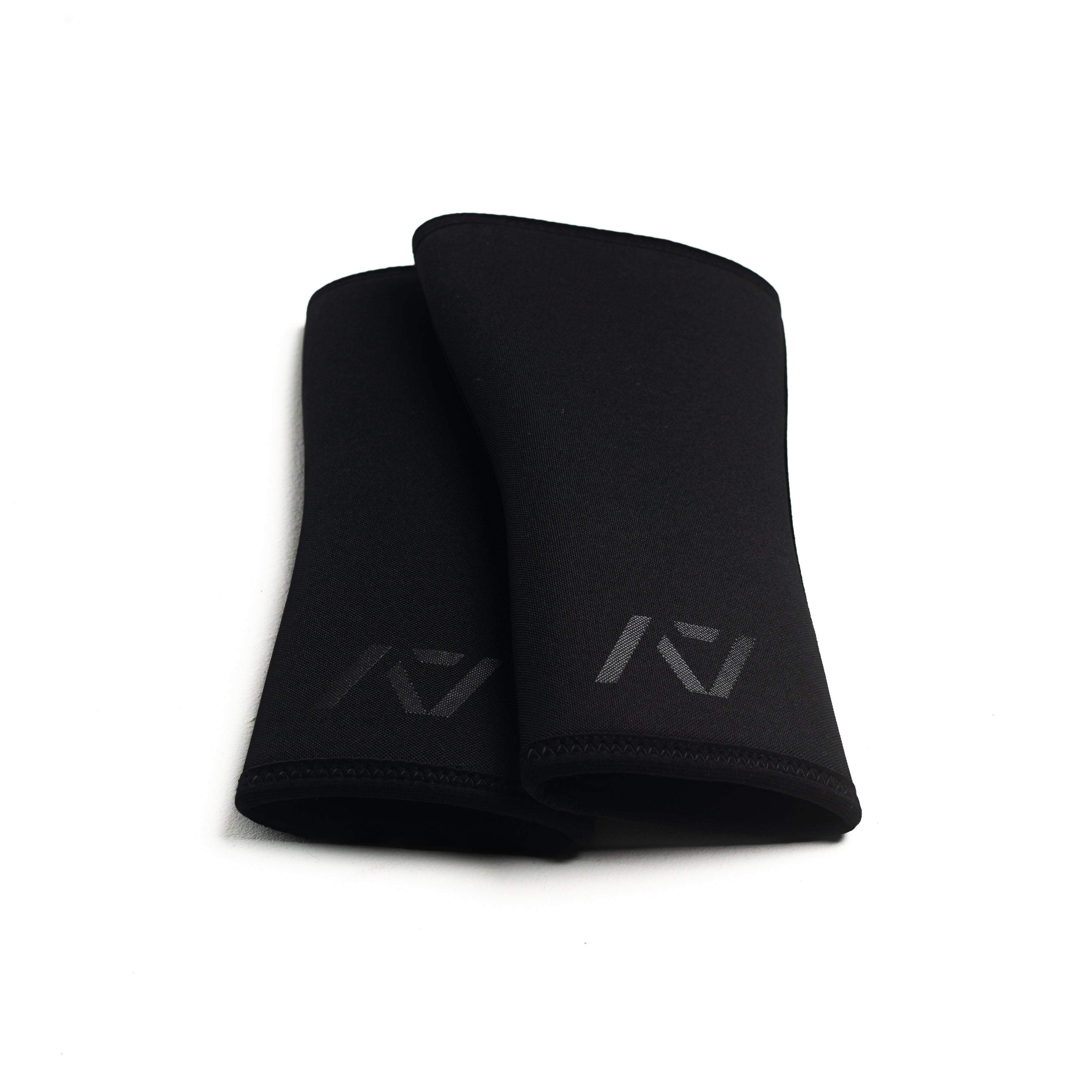 Flat lay of A7 Hourglass Knee Sleeves – Stealth pair, illustrating hourglass design.