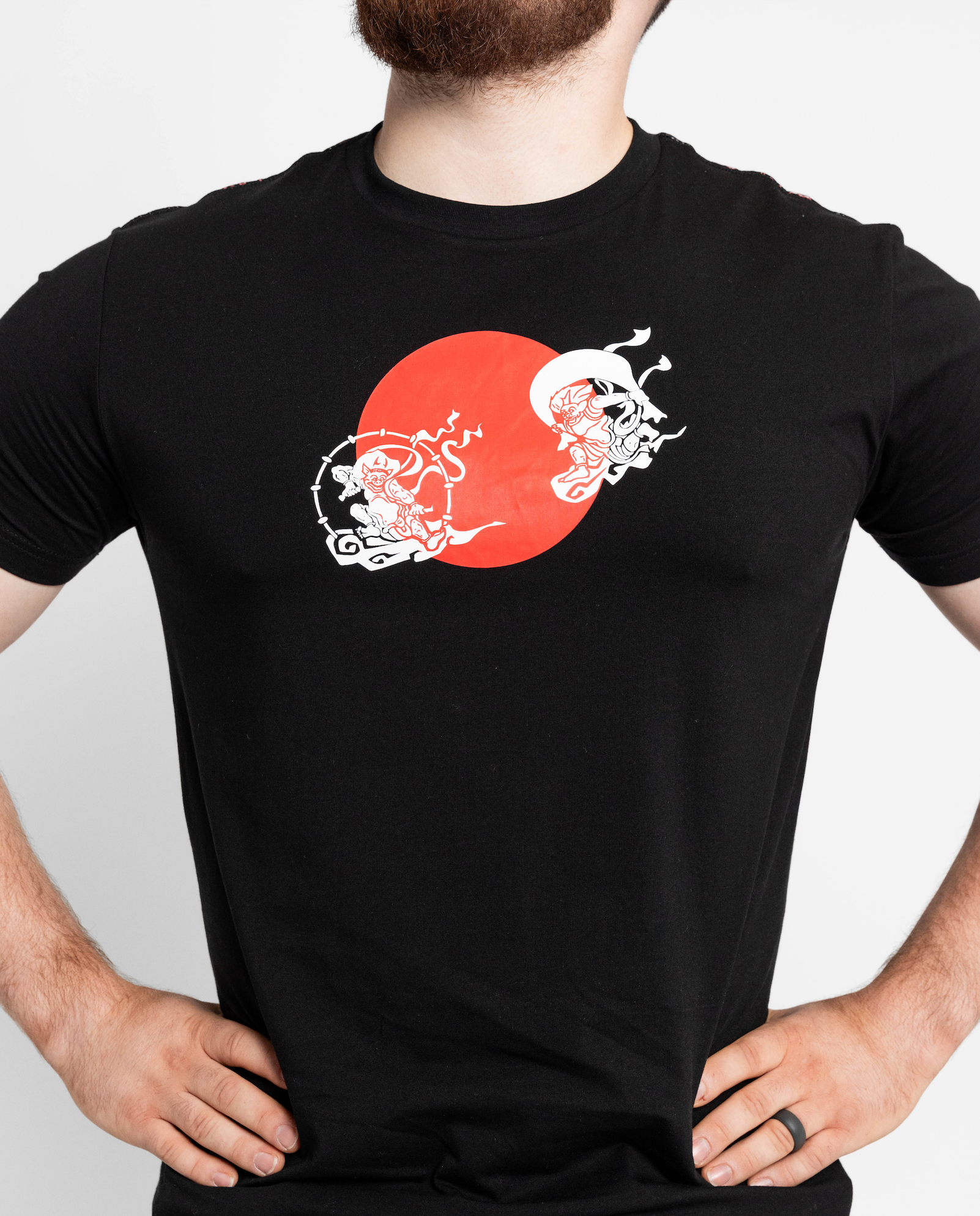 Black t-shirt with a red and white graphic design on a plain background