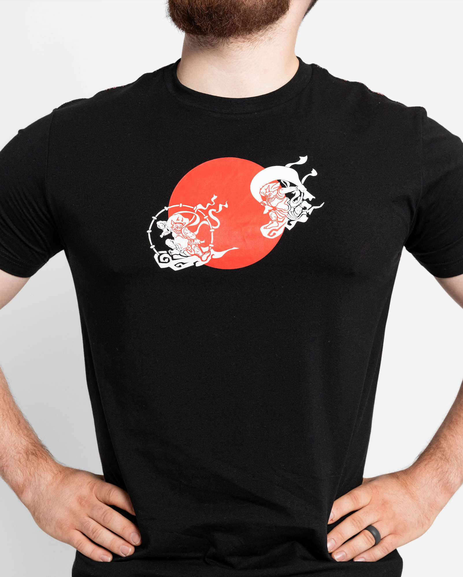 Black t-shirt with a red and white graphic design on a plain background