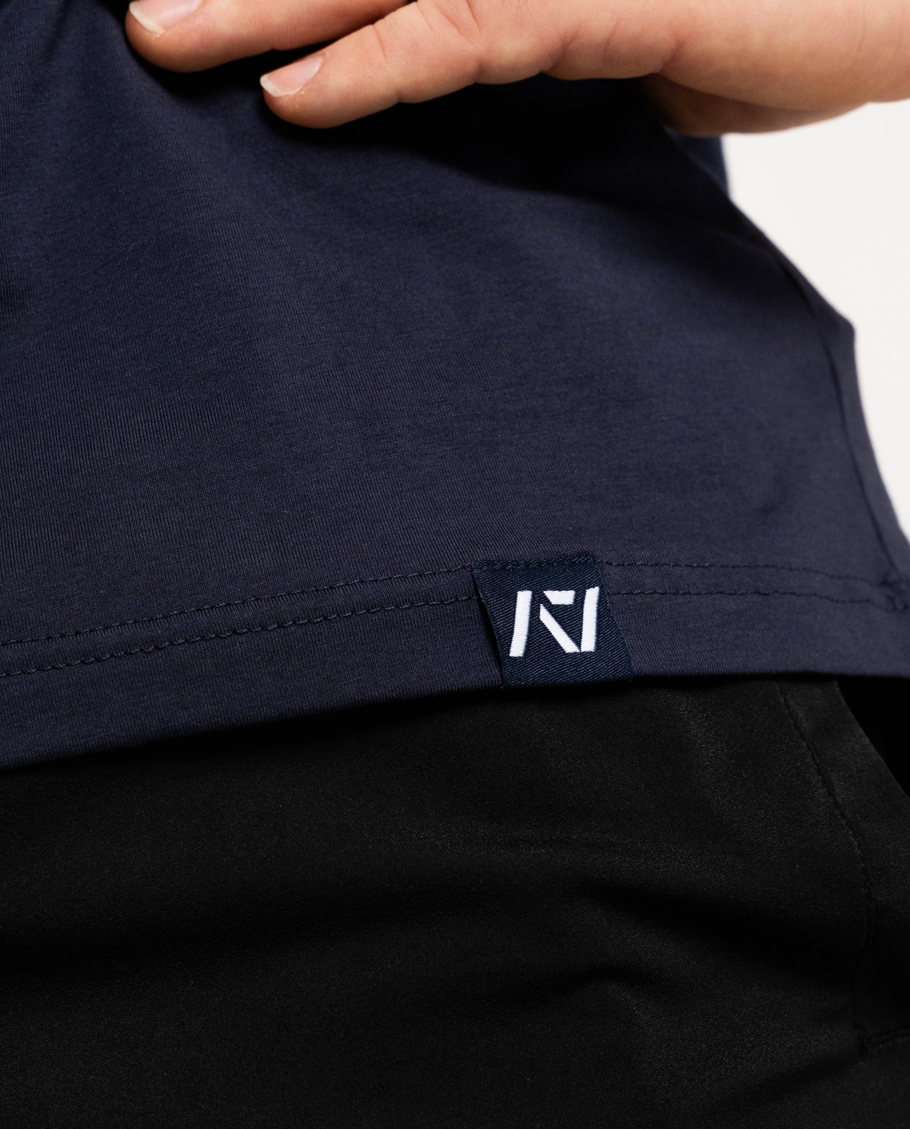 Close up of hem tag with a7 logo on NSTP mens bar grip shirt