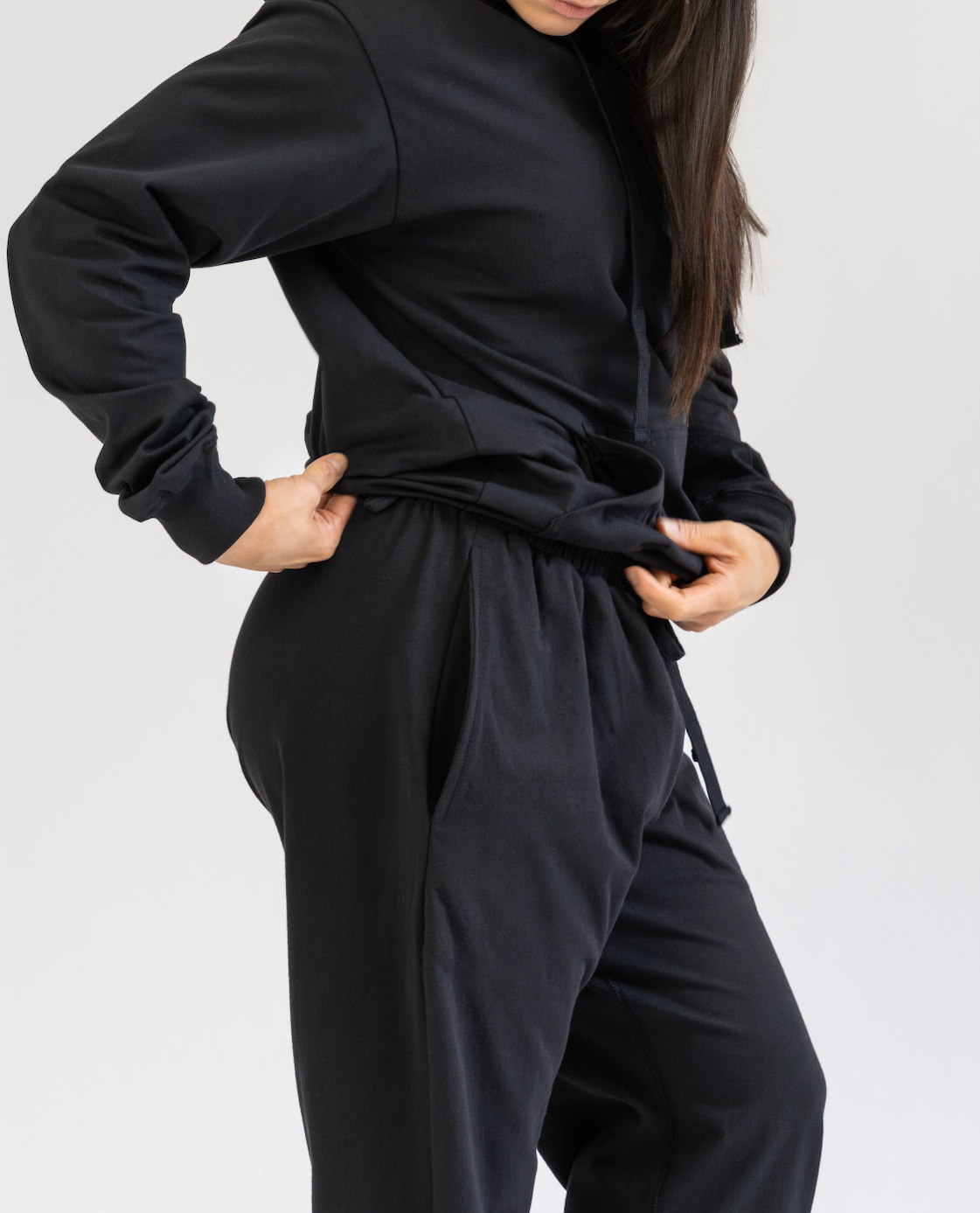 Person wearing a black outfit on a plain background