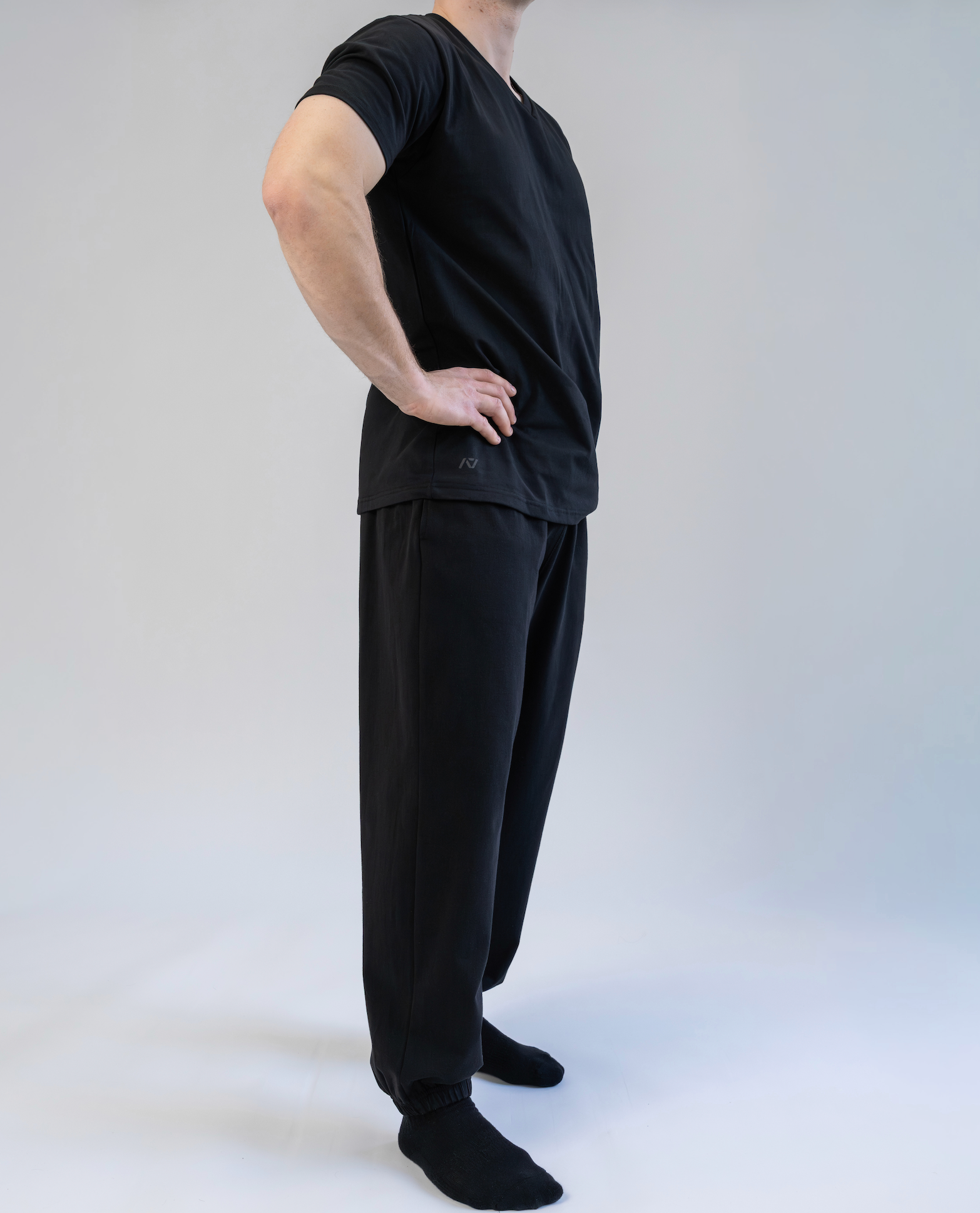 Person wearing a black outfit on a white background