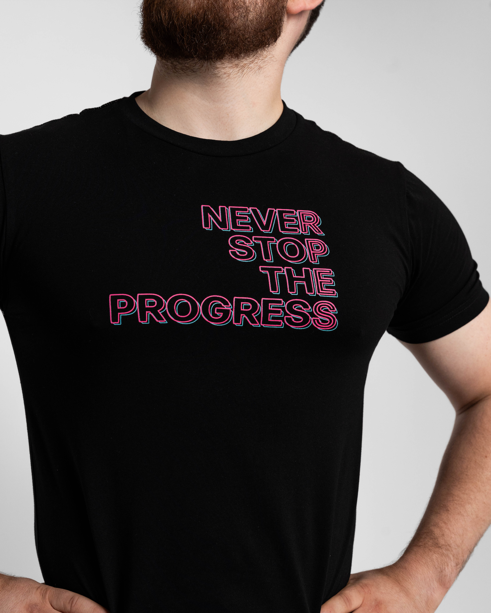 Person wearing a black t-shirt with 'Never Stop The Progress' text.