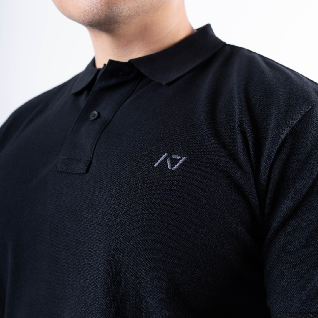 Close-up of the rib-knit polo collar on the A7 Cotton Polo in Black.