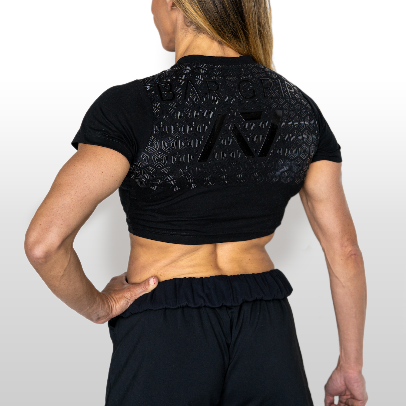 Person wearing a black athletic outfit with A7 BAR GRIP on a white background