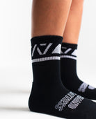 Close-up of the knit fabric on A7 Crew Socks in Black Domino, showing texture and stitching details.