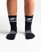 Front view of A7 Crew Socks in Black Domino, showcasing mid-shin length and ribbed cuff design.