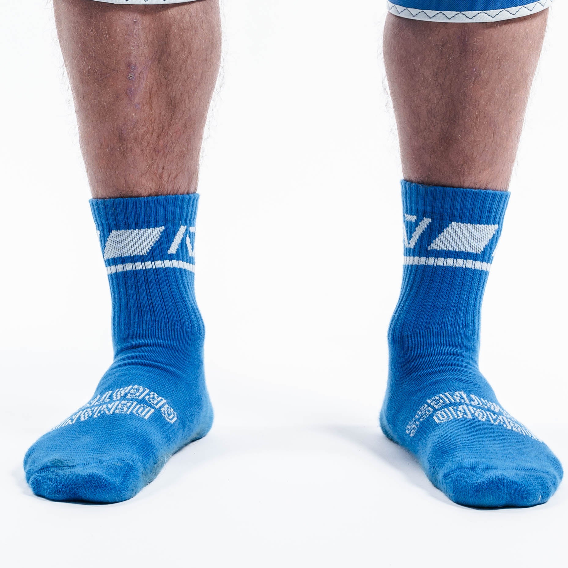 Front view of A7 Crew Socks in Cyanite featuring bold cyan base with pink A7 logo and ribbed cuff.