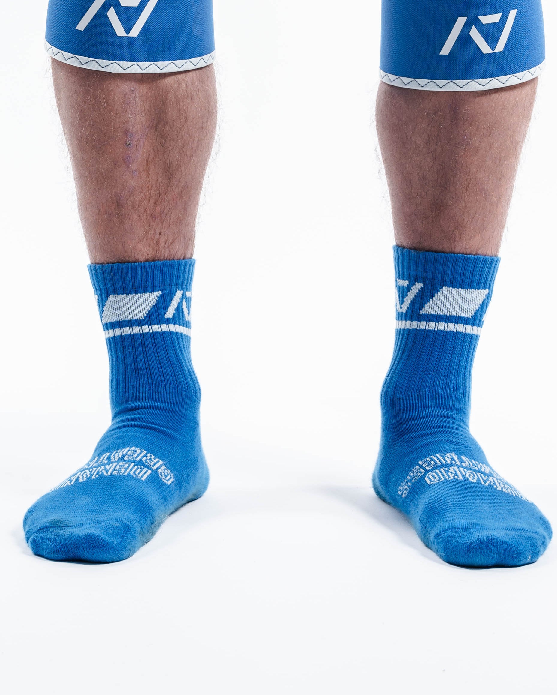 Front view of A7 Crew Socks in Cyanite featuring bold cyan base with pink A7 logo and ribbed cuff.