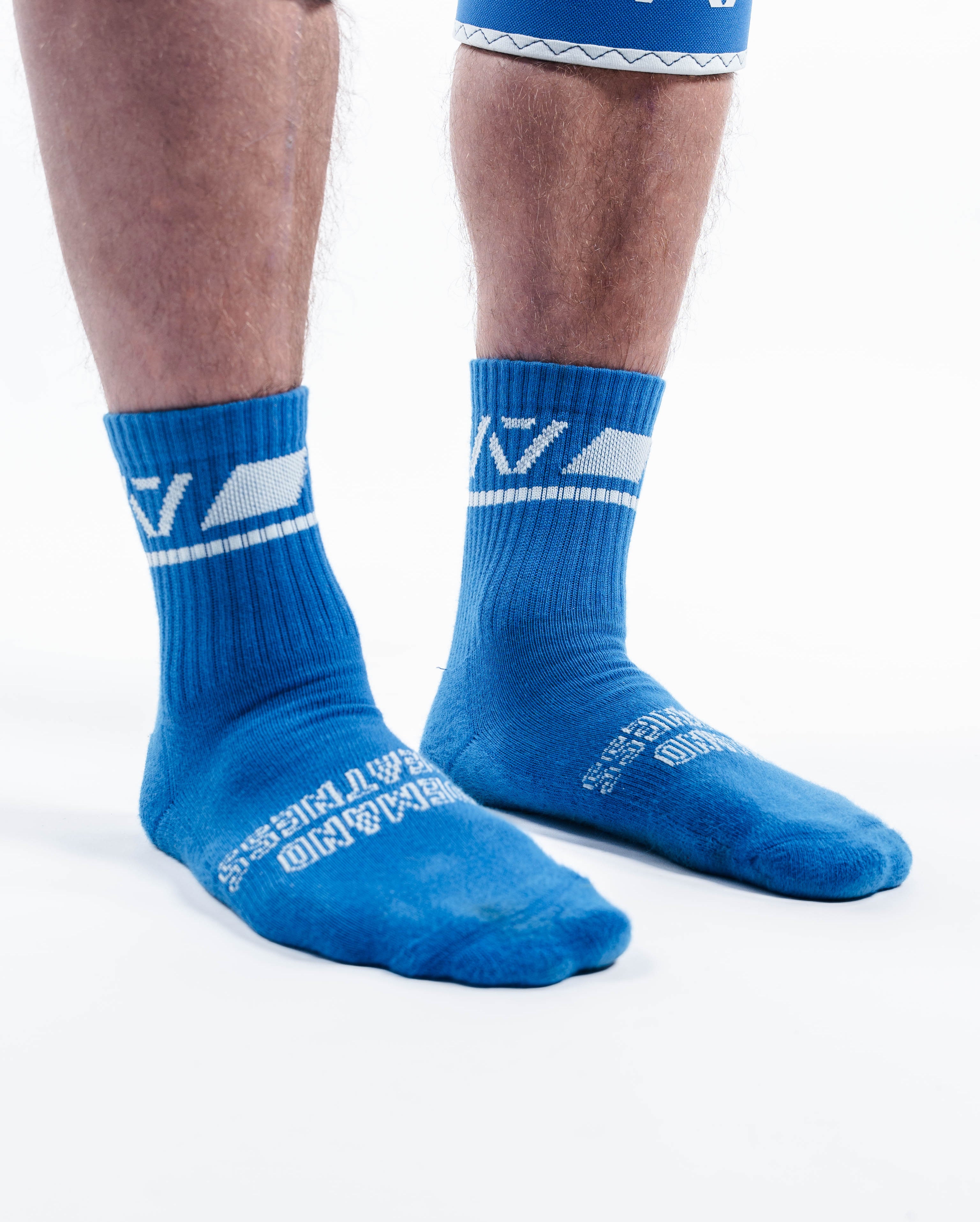 Side profile of A7 Crew Socks in Cyanite showing compression-style fit and contrast pink branding.