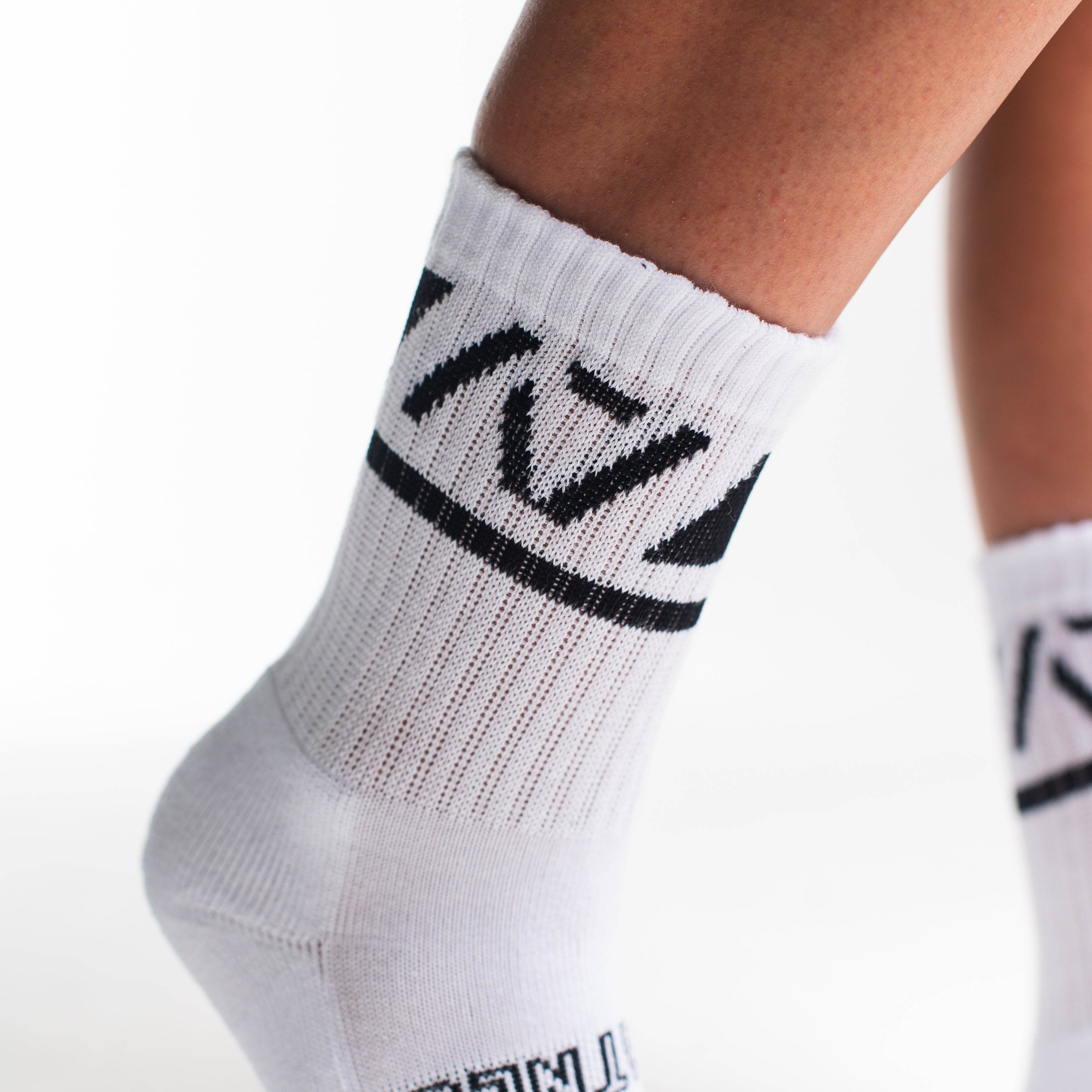 Close-up of the knit fabric on A7 Crew Socks in Domino White, showing texture and stitching details.