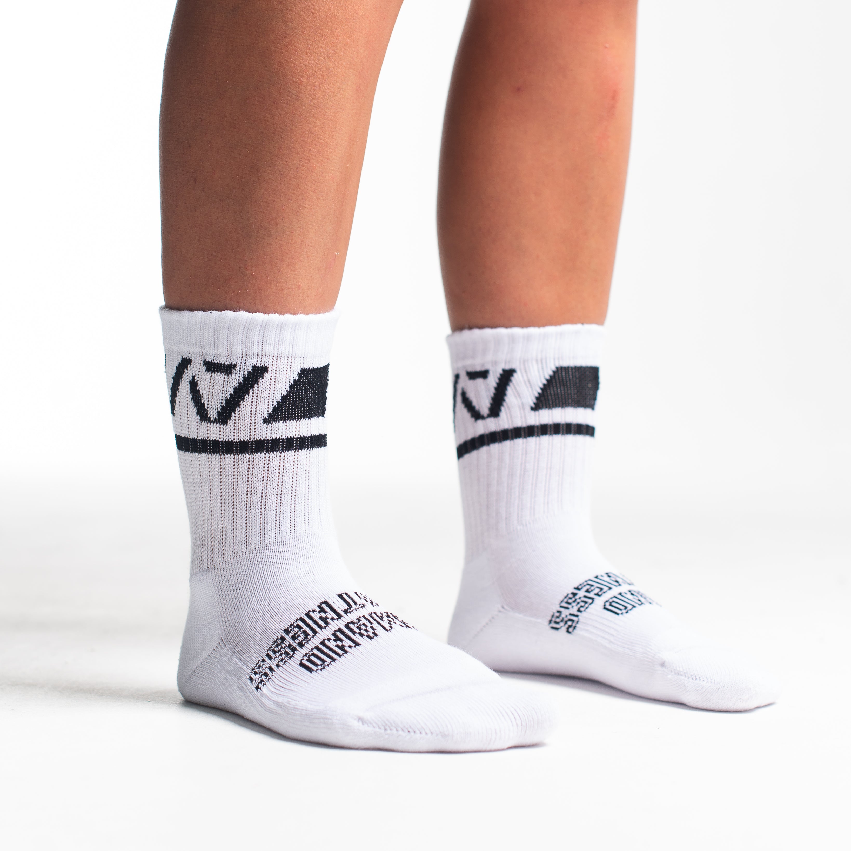 Side profile of A7 Crew Socks in Domino White, highlighting the A7 logo on the ankle and compression-style top.