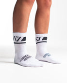 Side profile of A7 Crew Socks in Domino White, highlighting the A7 logo on the ankle and compression-style top.