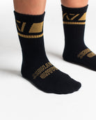 Close-up of the knit fabric on A7 Crew Socks in Gold Standard, showing texture and stitching details.