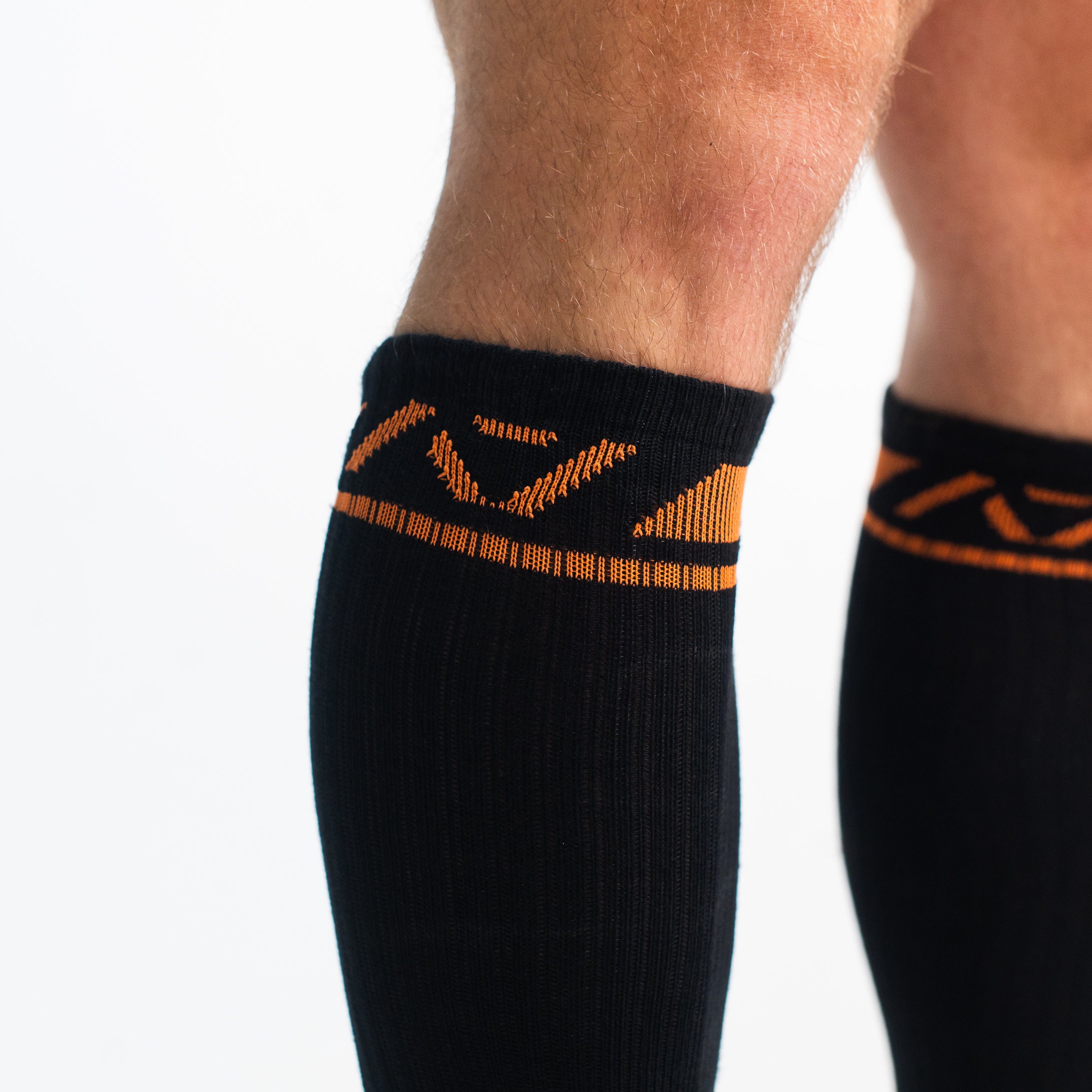 Close-up of the knit fabric on A7 Deadlift Socks in Blaze, showing texture and stitching details.