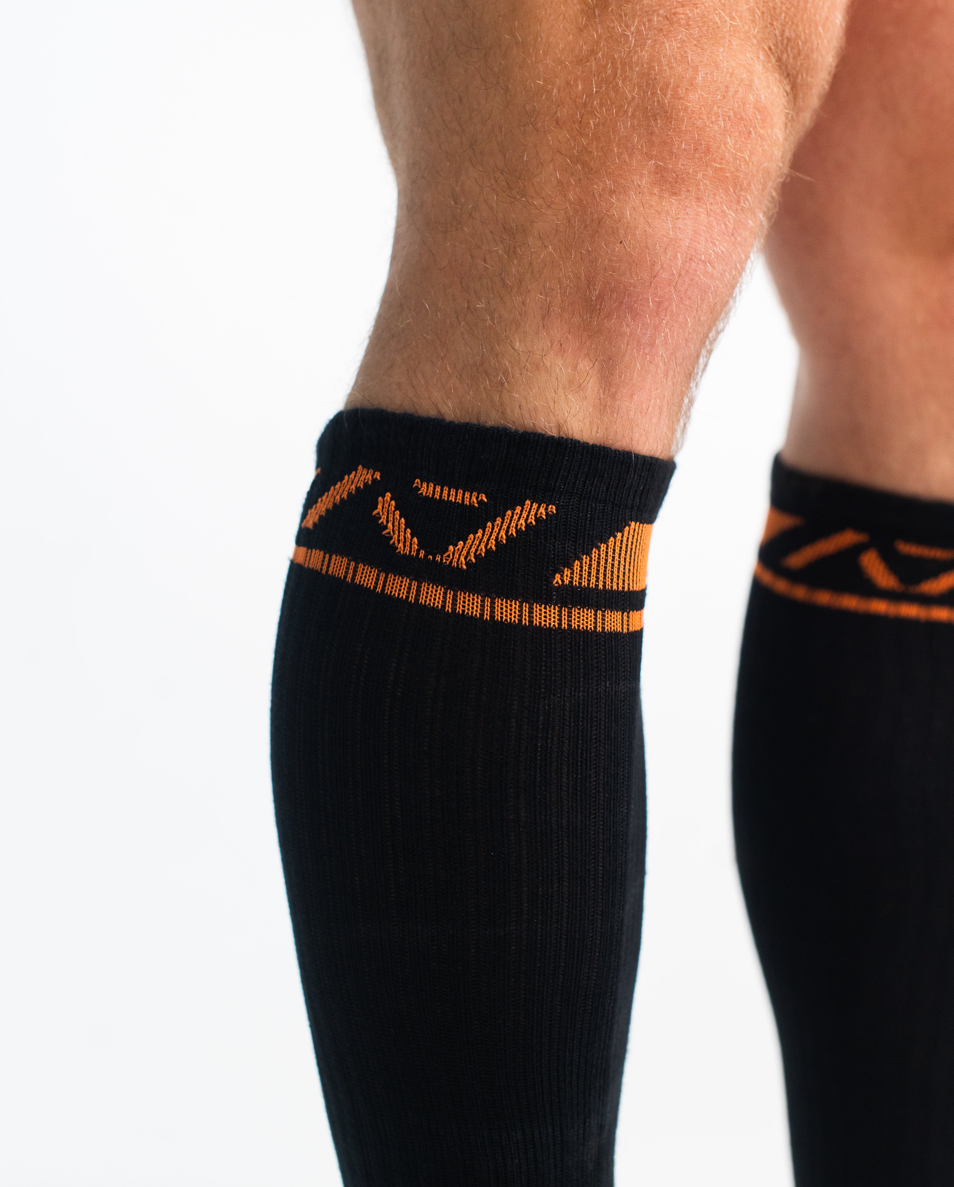 Close-up of the knit fabric on A7 Deadlift Socks in Blaze, showing texture and stitching details.