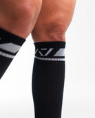 Close-up of the knit fabric on A7 Deadlift Socks in Domino Black, showing texture and stitching details.