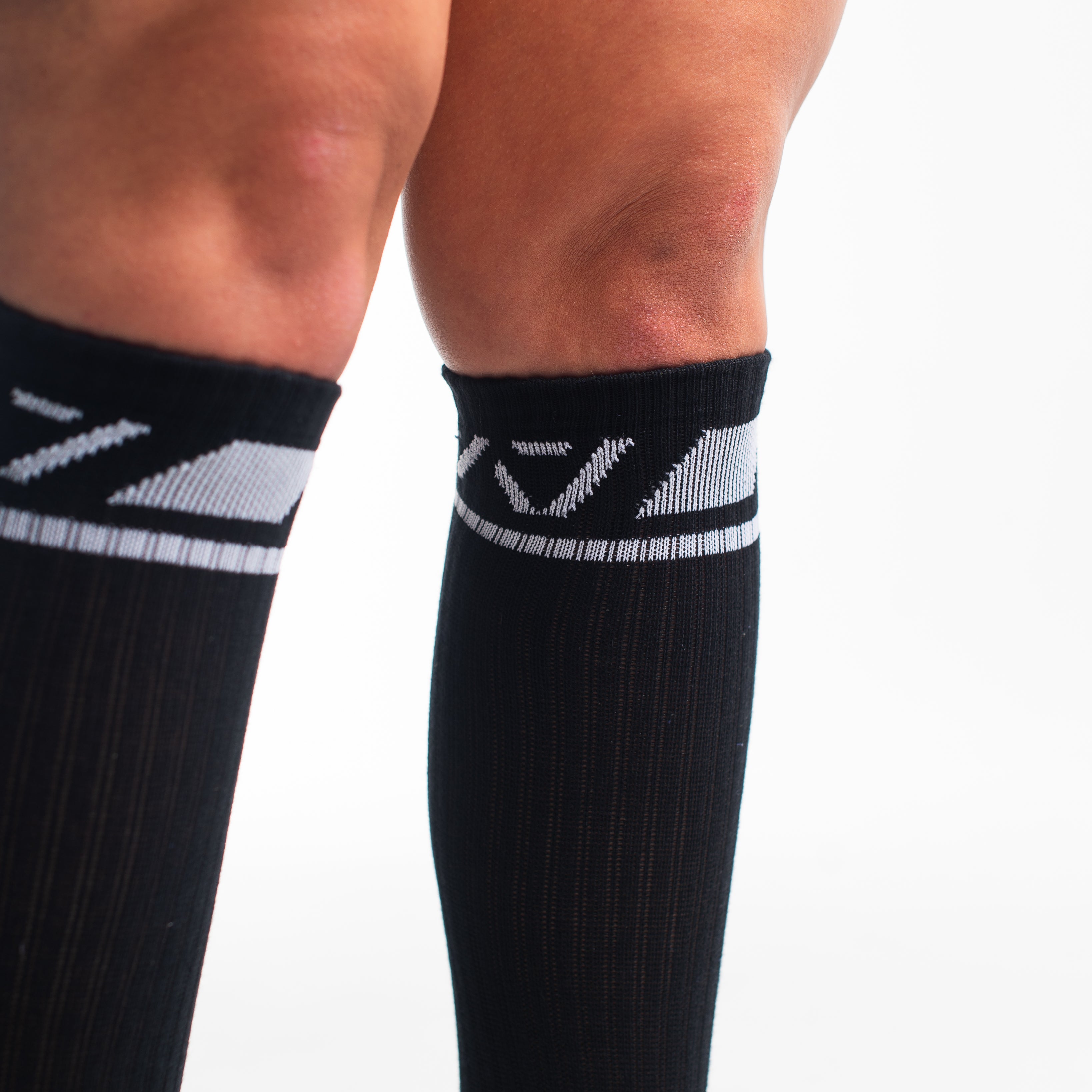 Close-up of the knit fabric on A7 Deadlift Socks in Domino Black, showing texture and stitching details.