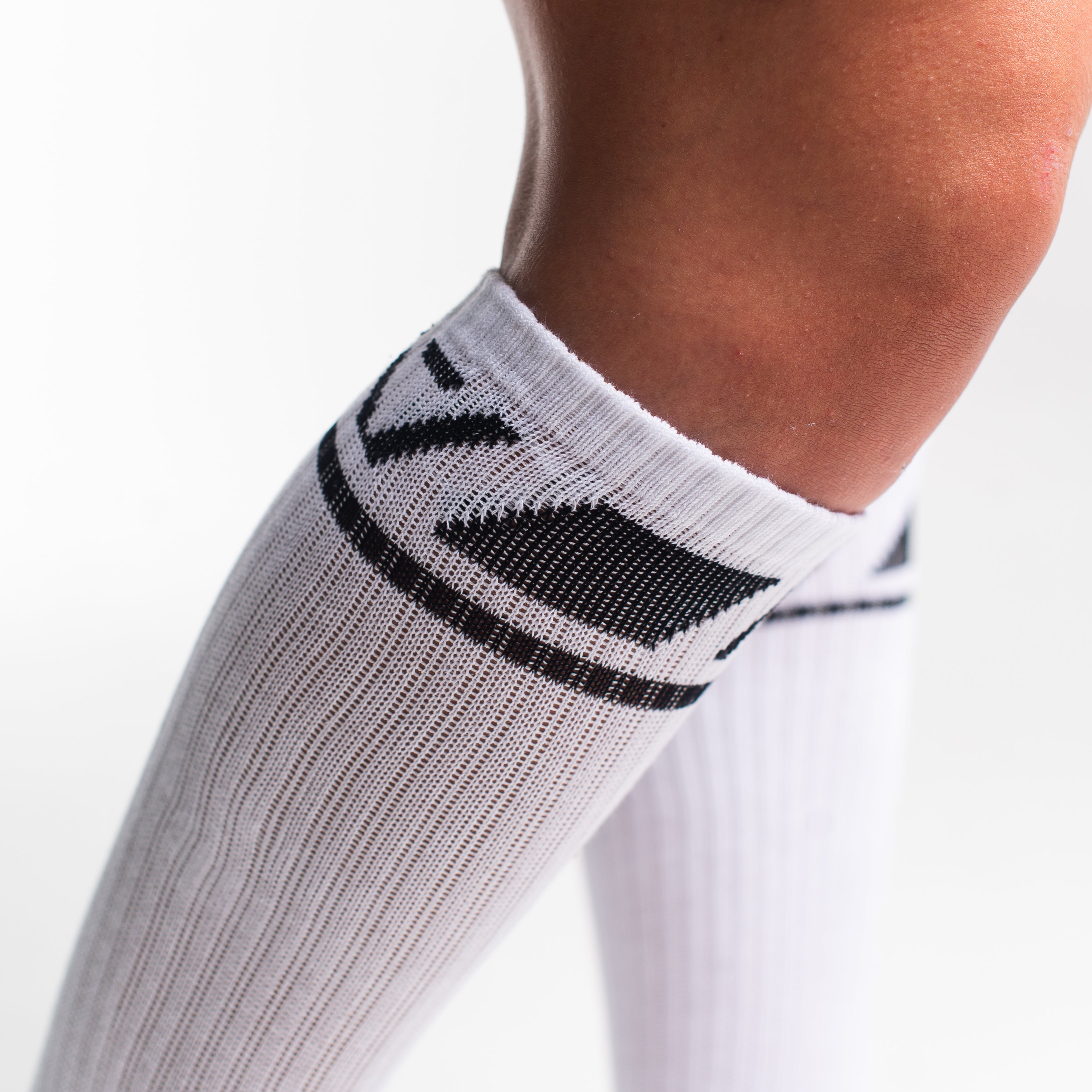 Close-up of the knit fabric on A7 Deadlift Socks in Domino White, showing texture and stitching details.