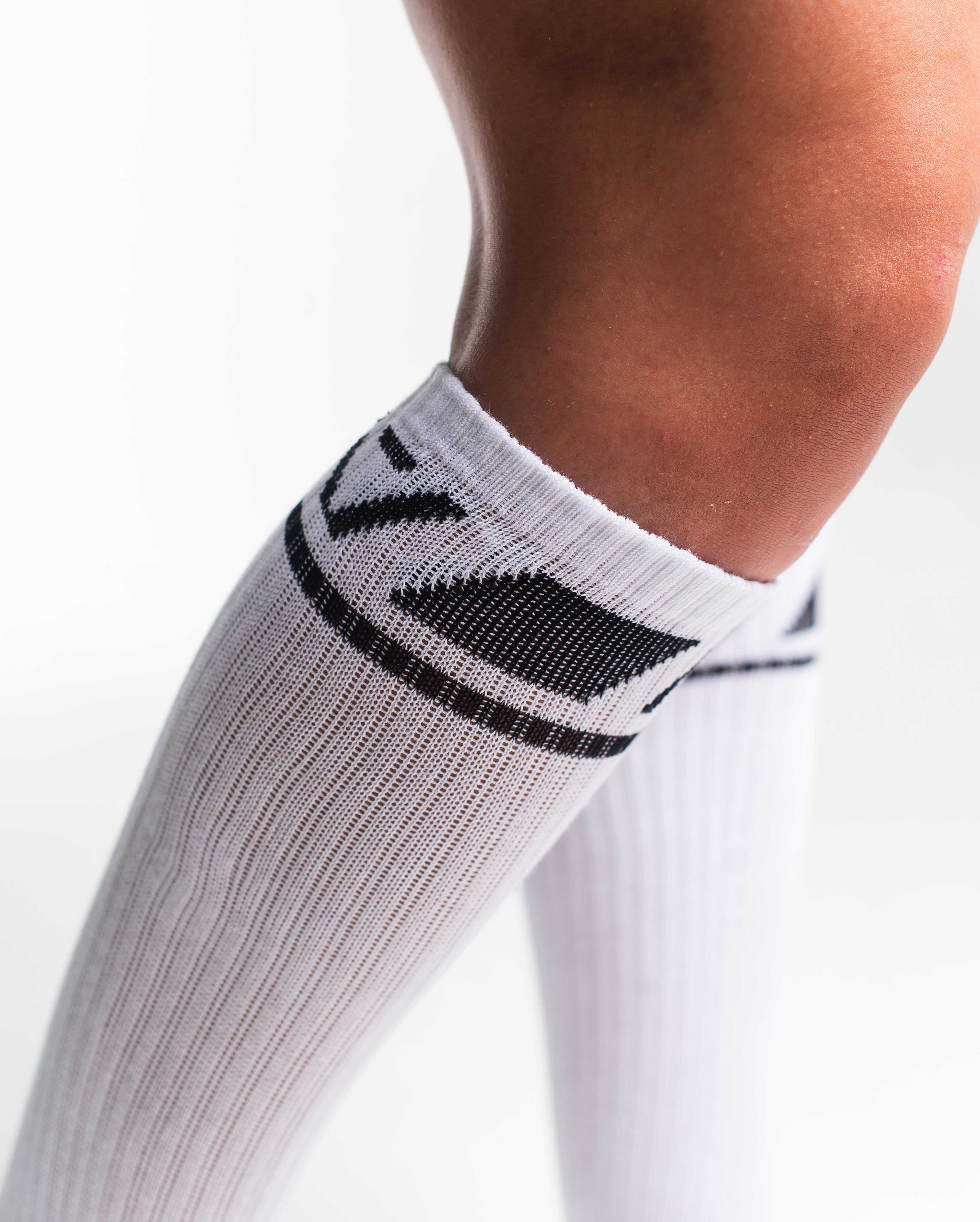 Close-up of the knit fabric on A7 Deadlift Socks in Domino White, showing texture and stitching details.