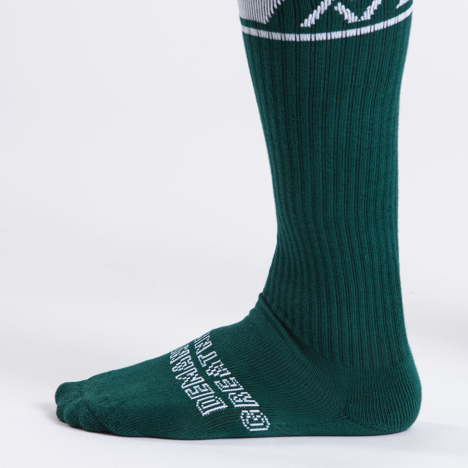 Close-up of the knit fabric on A7 Deadlift Socks in Emerald Forás, showing texture and stitching details.