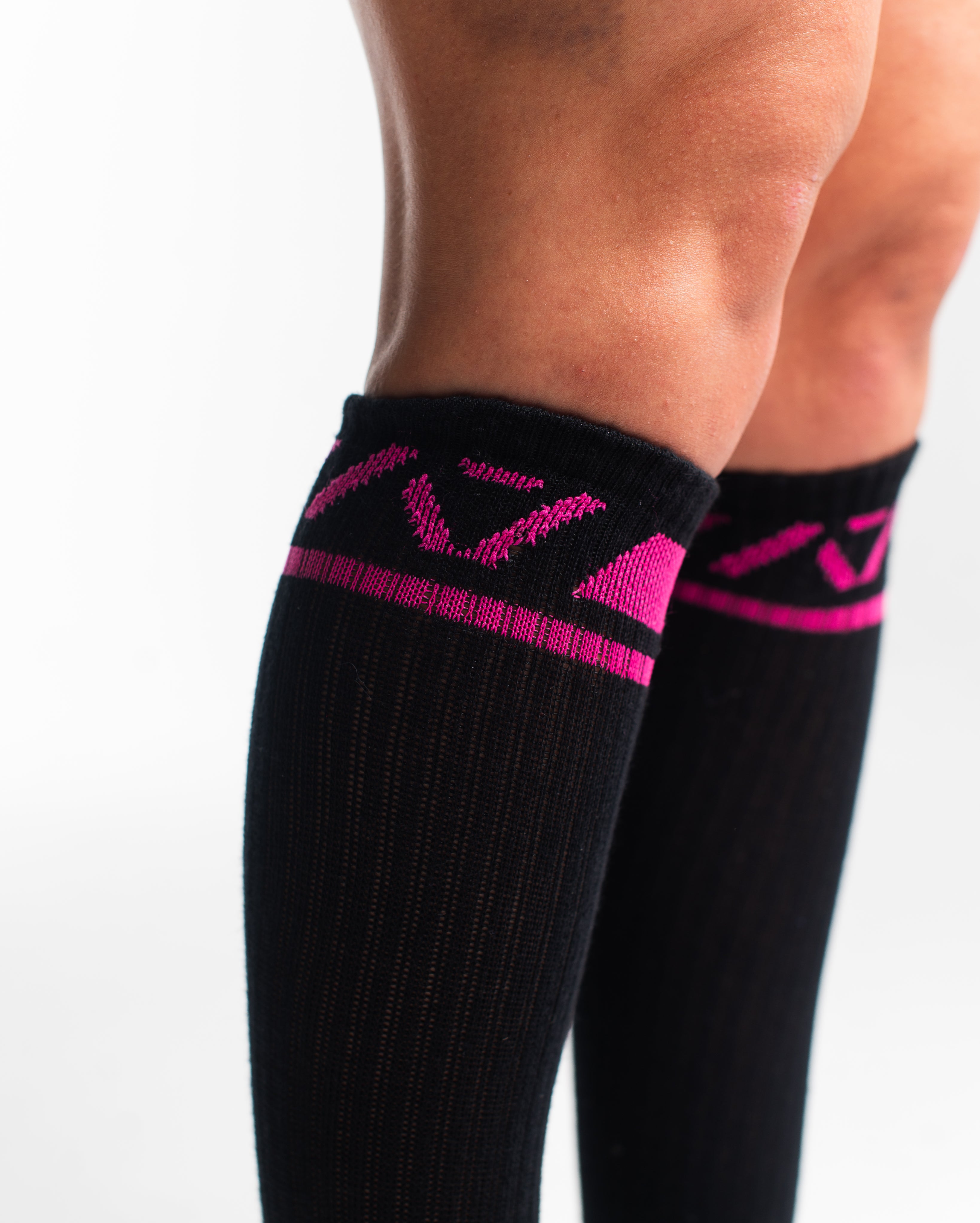 Close-up of the knit fabric on A7 Deadlift Socks in Flamingo, showing texture and stitching details.