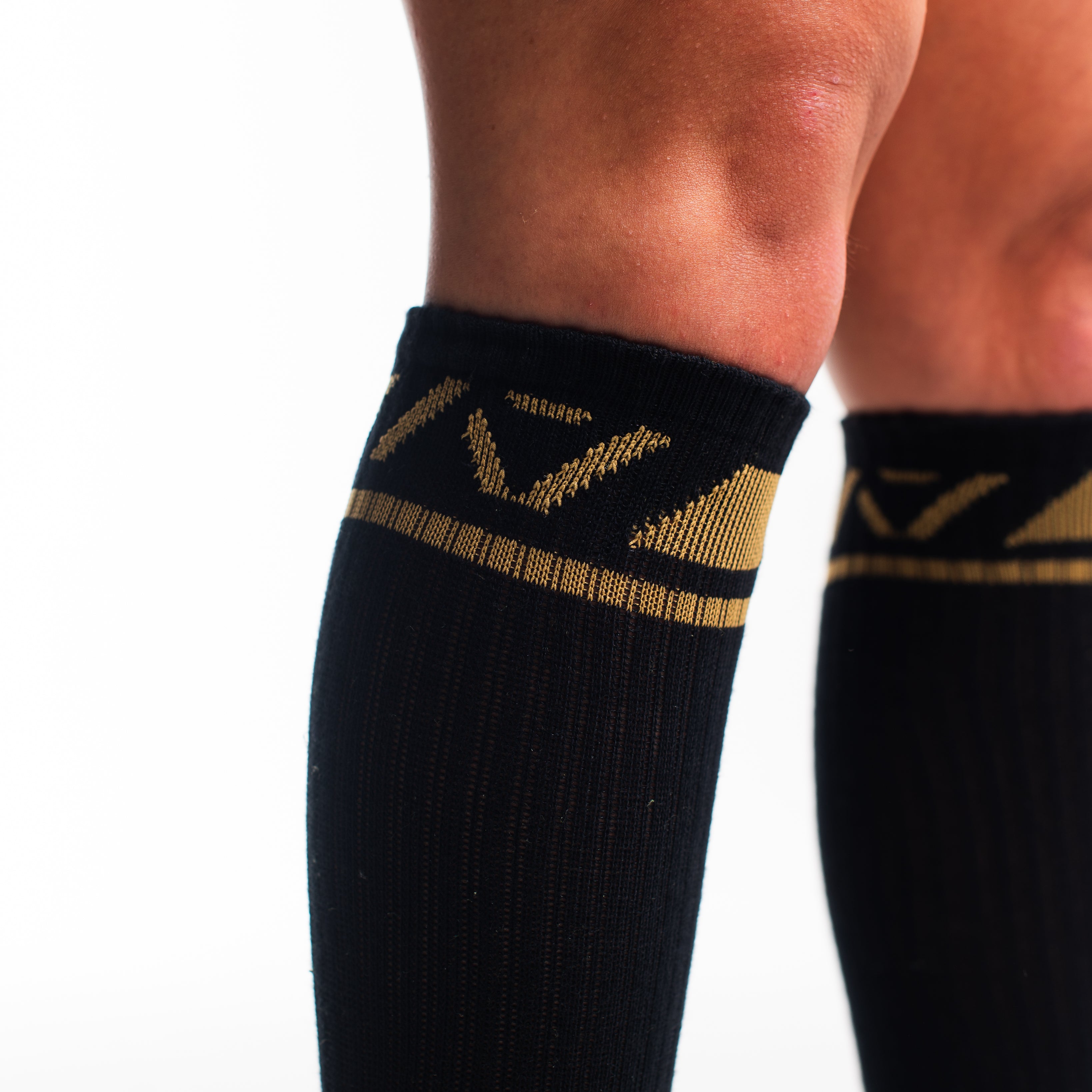Close-up of the knit fabric on A7 Deadlift Socks in Gold Standard, showing texture and stitching details.