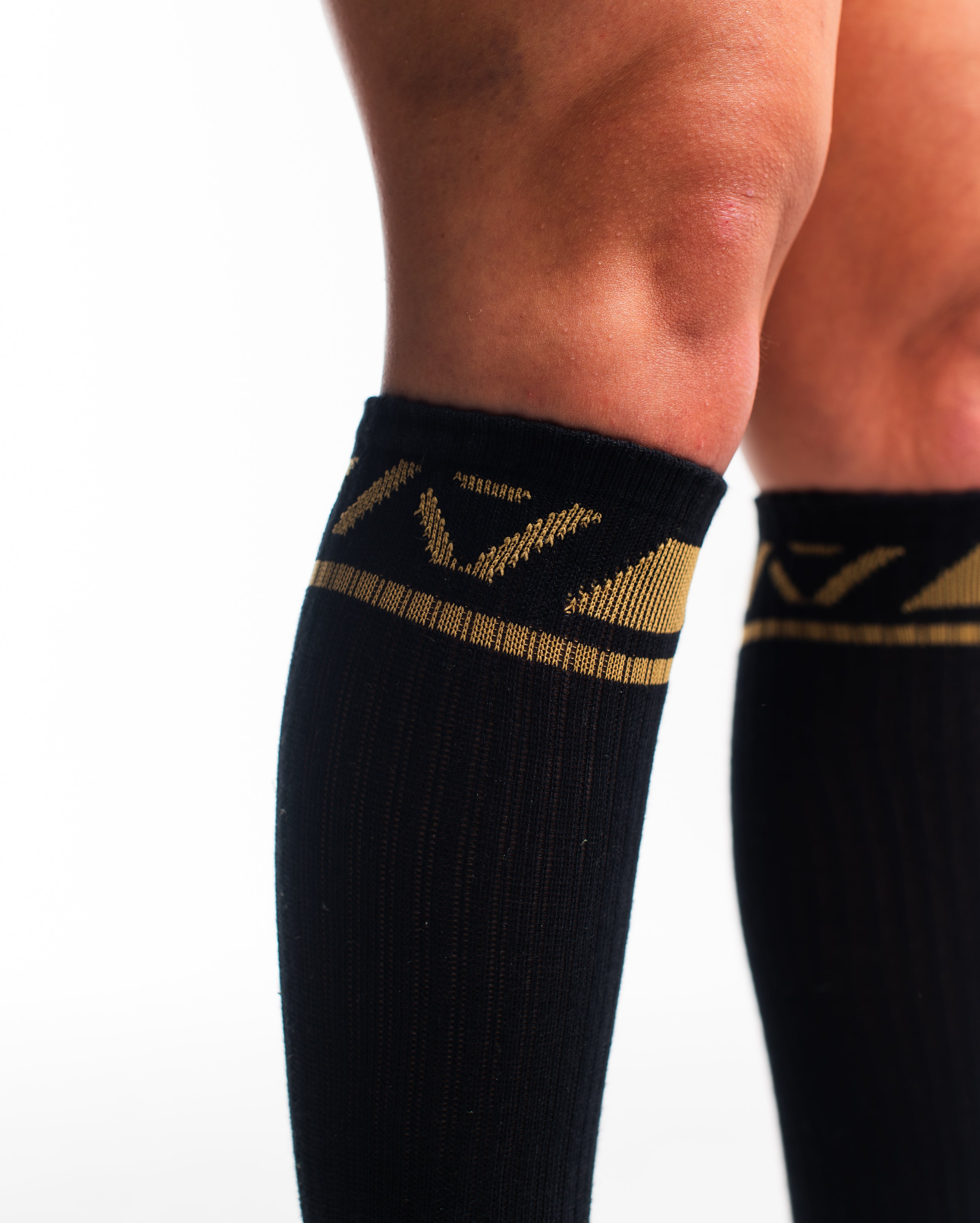 Close-up of the knit fabric on A7 Deadlift Socks in Gold Standard, showing texture and stitching details.