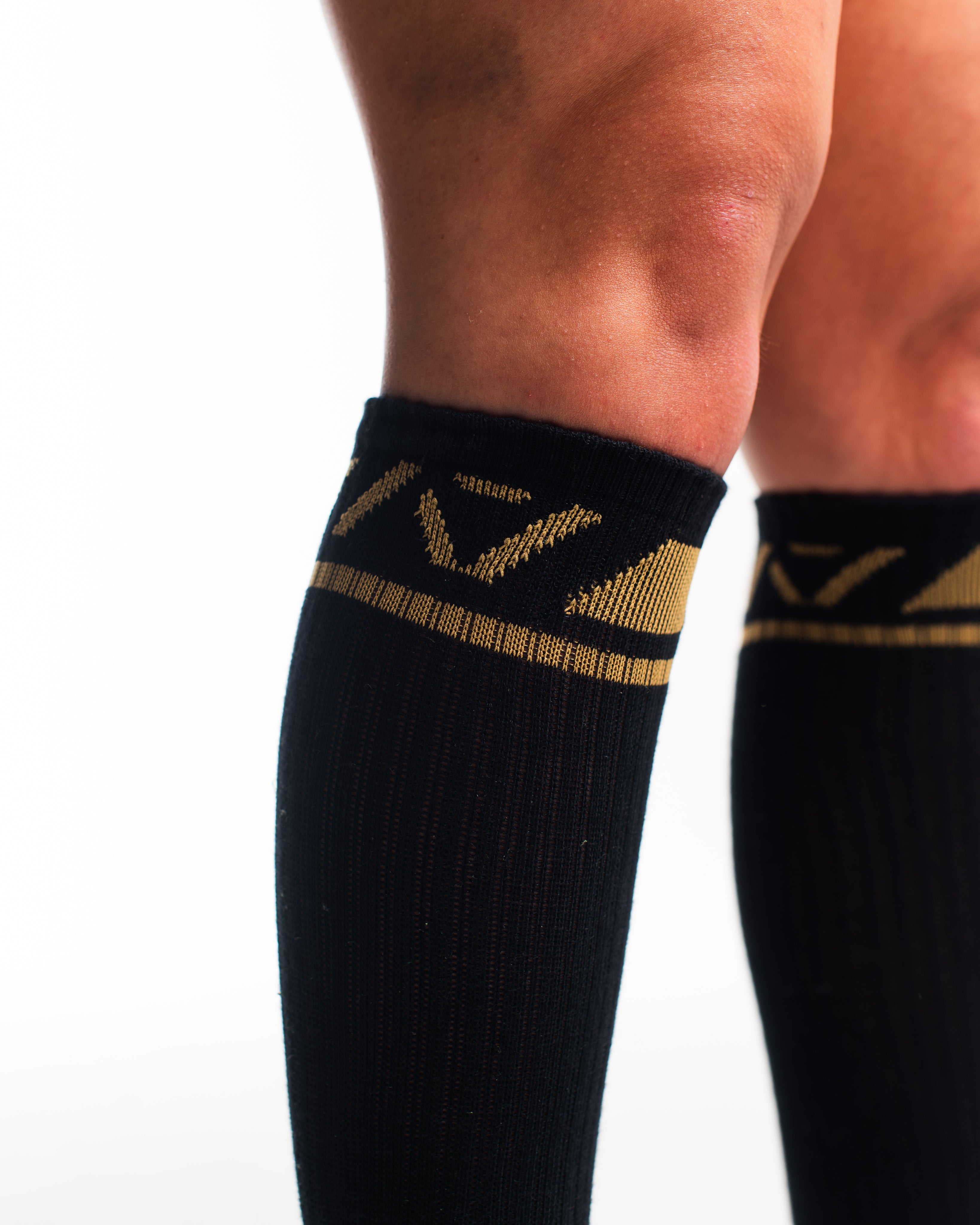 Close-up of the knit fabric on A7 Deadlift Socks in Gold Standard, showing texture and stitching details.