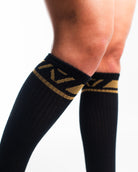Close-up of the knit fabric on A7 Deadlift Socks in Gold Standard, showing texture and stitching details.