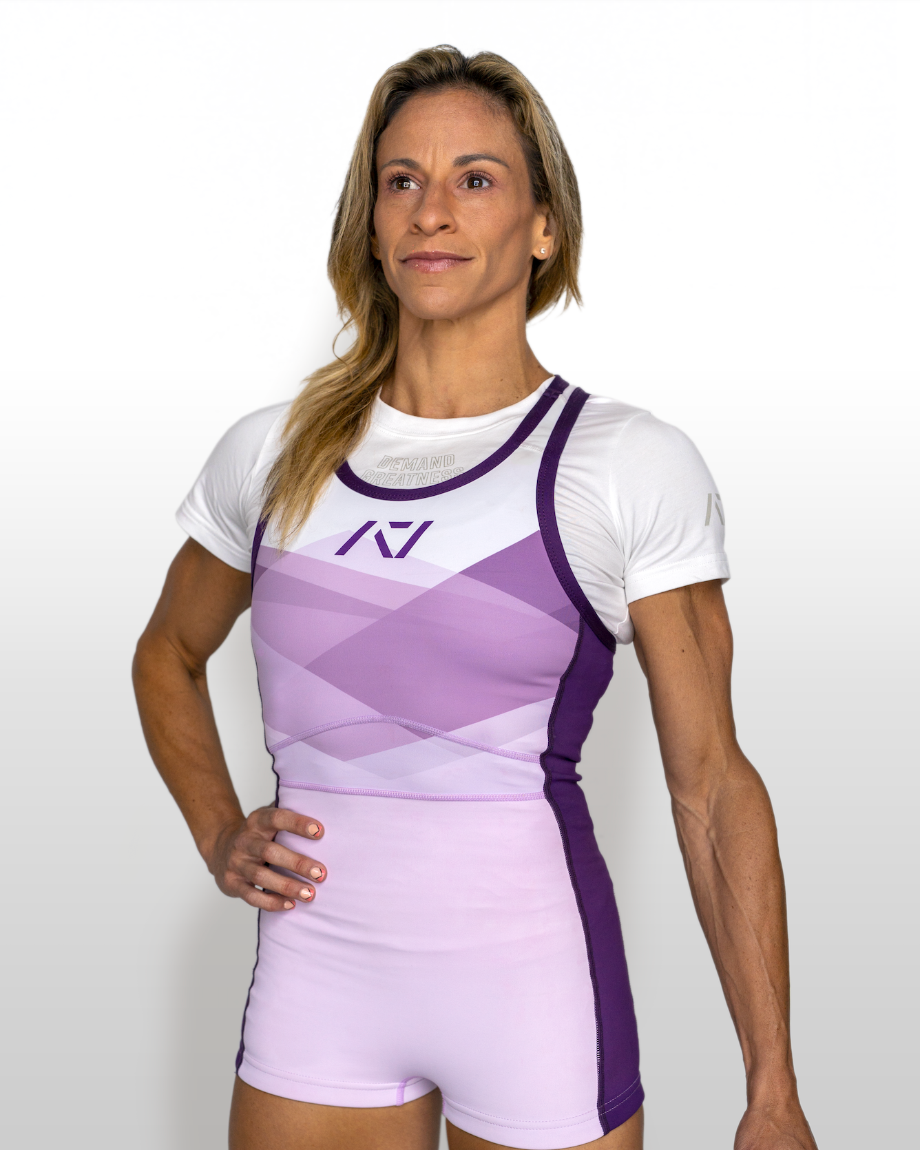 Woman wearing a white and purple IPF approved singlet with a logo on a white background