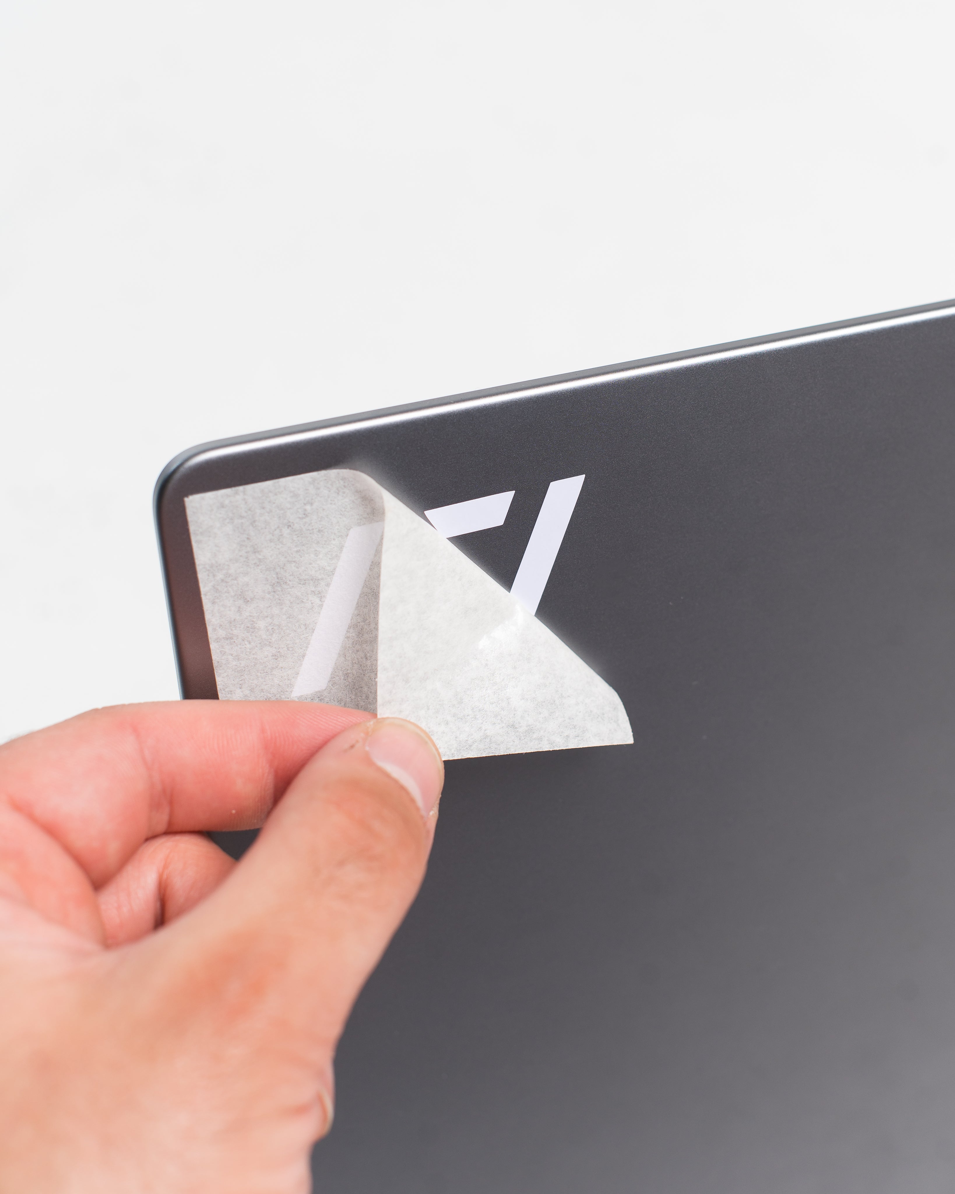 A7 White Decal being applied by hand with peel-and-stick backing, designed for easy and precise placement.