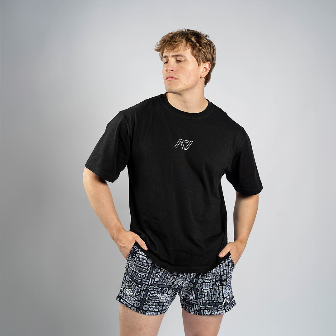 Front view of Affirmation Over-Fit Shirt – Domino featuring oversized unisex fit and white A7 logo print on black fabric.