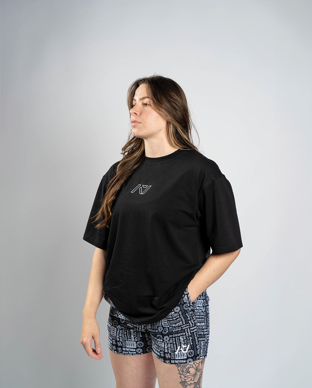 Front view of Affirmation Over-Fit Shirt – Domino featuring oversized unisex fit and white A7 logo print on black fabric.