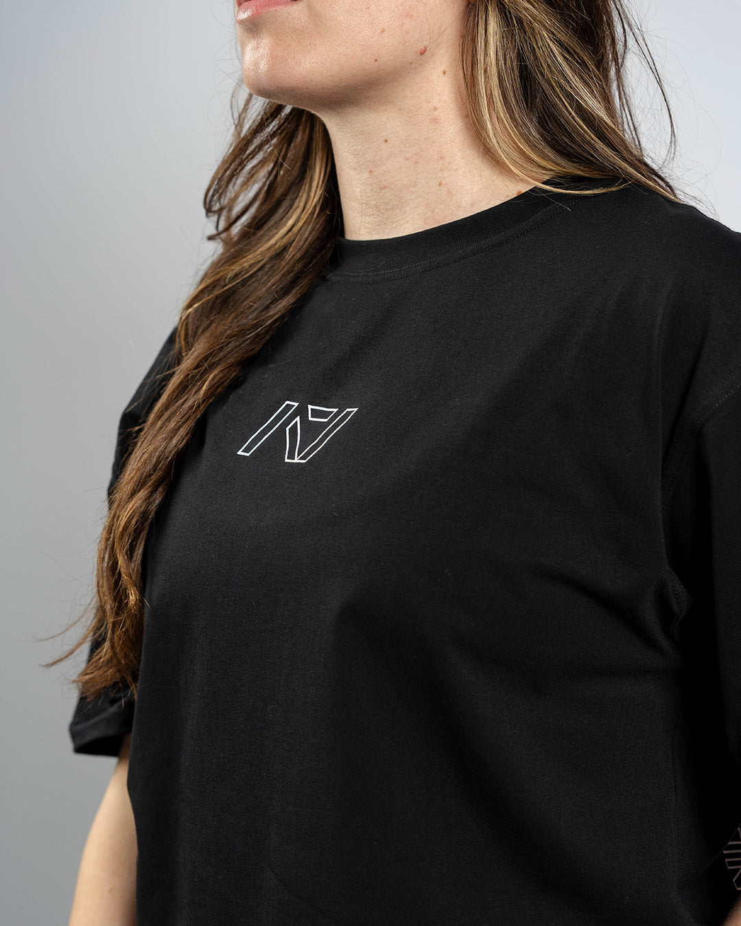 Close-up of white A7 logo on the Domino over-fit shirt showing sharp contrast print and clean branding.