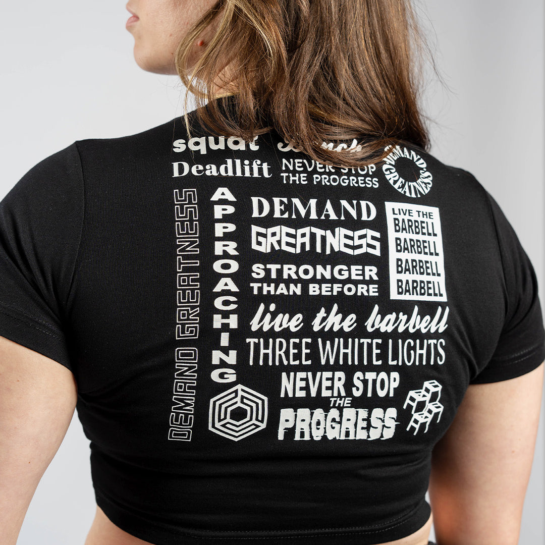 Back view of A7 Affirmation True-Fit Women's Crop – Domino showcasing motivational mantras in white text on black fabric.