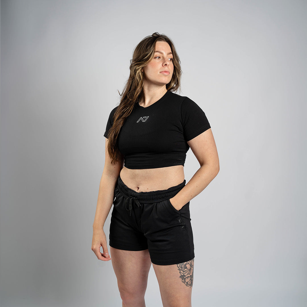 Athlete wearing the A7 Affirmation True-Fit Women's Crop – Domino demonstrating fit and style in a gym setting.