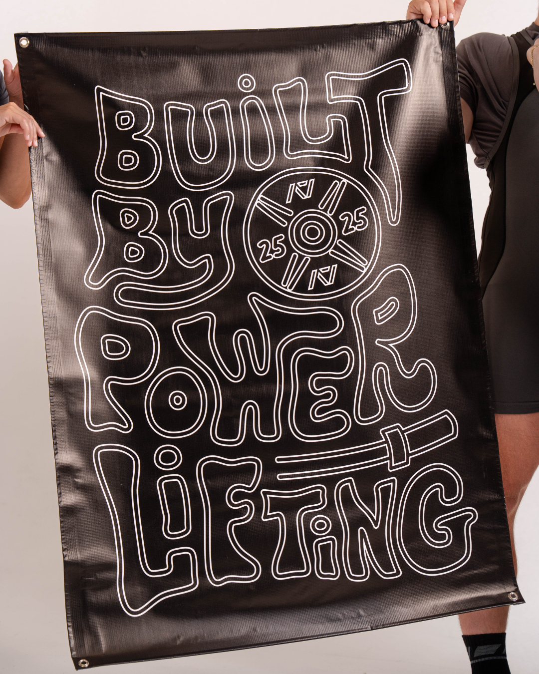 Front view of the A7 Built By Banner displaying bold "Built By" text on durable black vinyl.