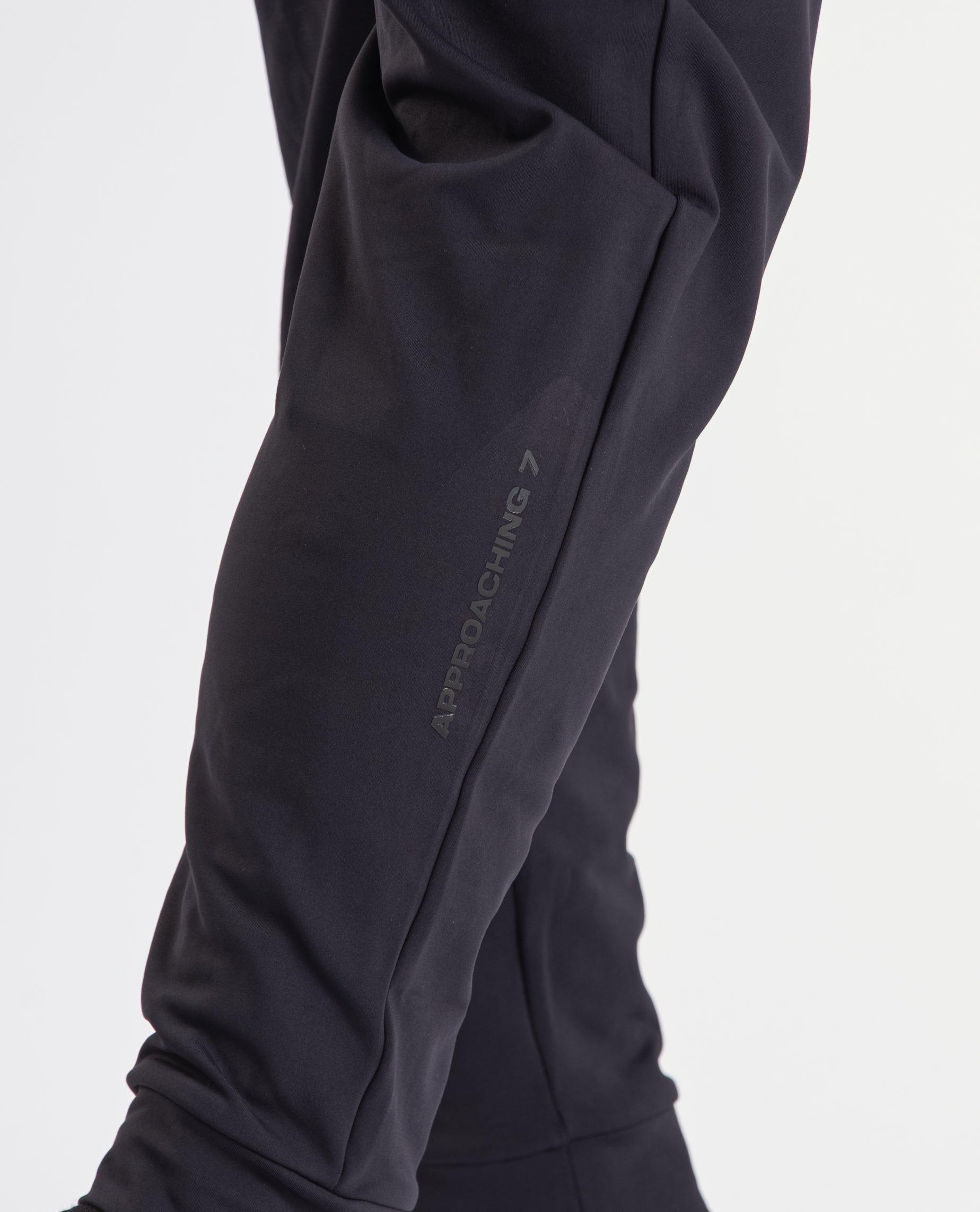 Close-up of the printed silicone A7 logo on the left leg of the Cobra 360Go 1Z Joggers in Stealth.